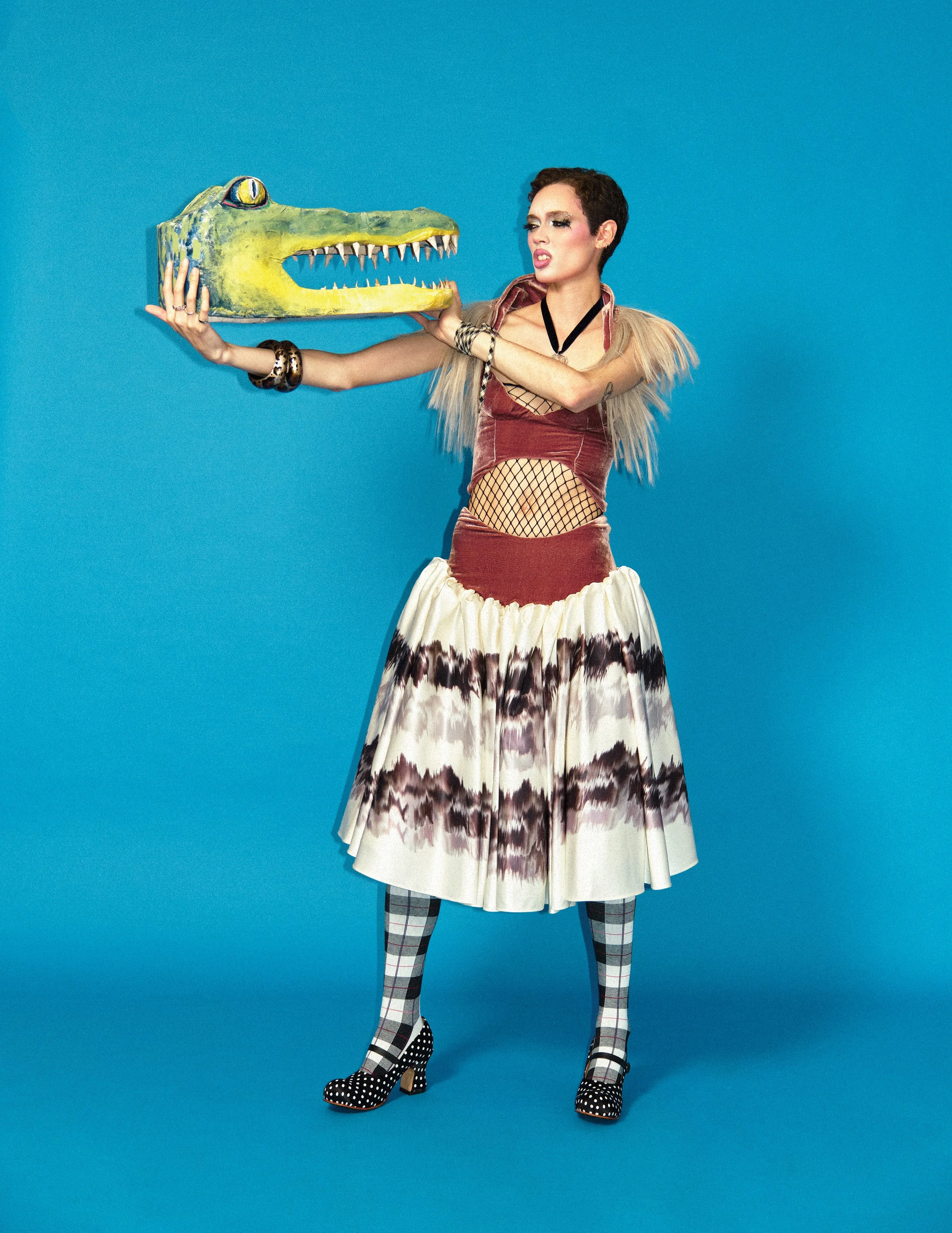 Fashion model Brynn Bonner holds an alligator head created by Indie Studios artist Sam Bates from the editorial "Vive La Revolution" directed by fashion film director Indie Studios.  Indie Studios is one of the best Fashion photographers in new york