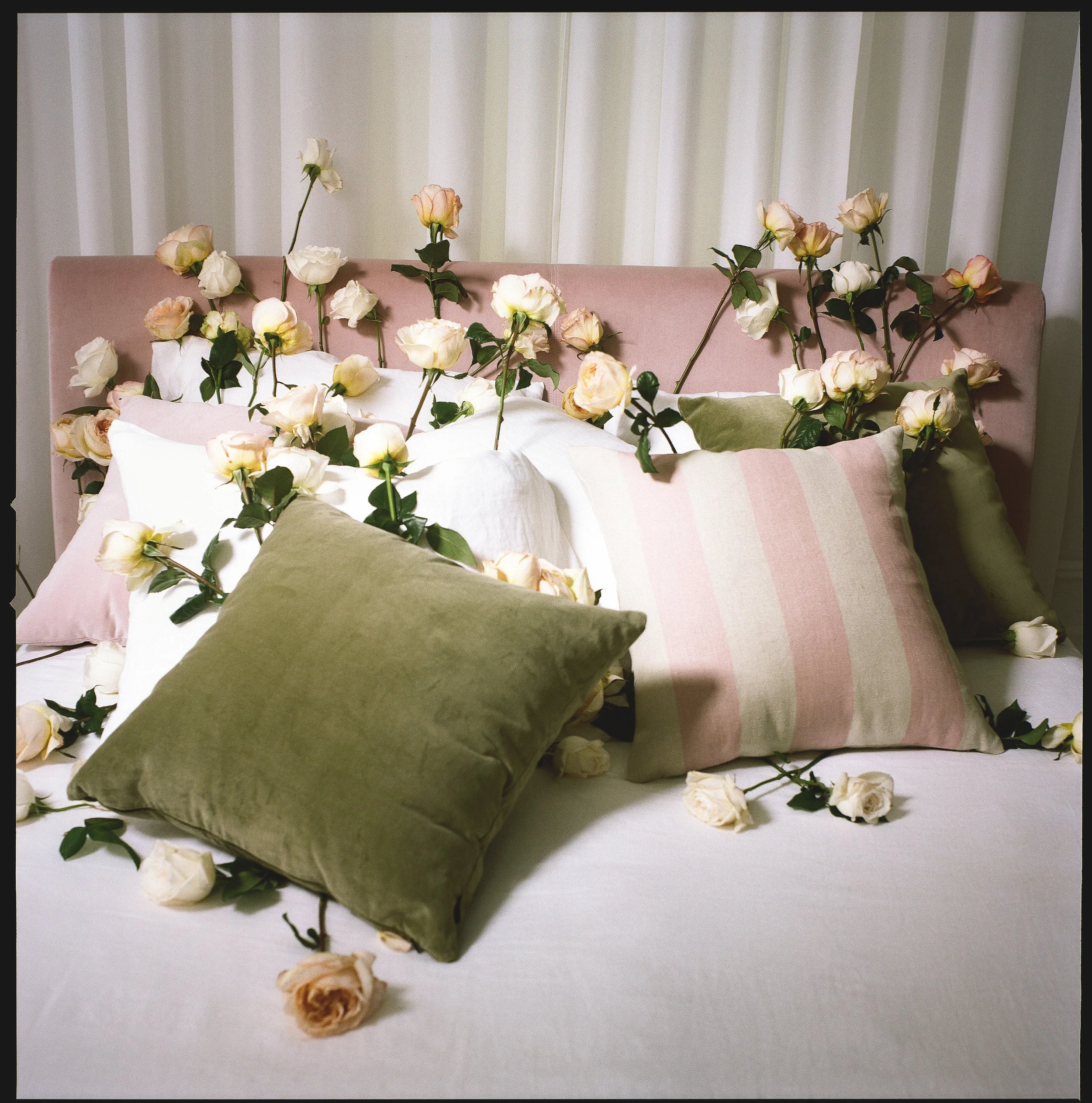 Medium format film still-life for advertising campaign with whimsical British furniture designer features romantic pink bed scattered with pink roses by New York set designer, Lane Vineyard, directed by Sam Bates and Andrew White of Indie Studios.