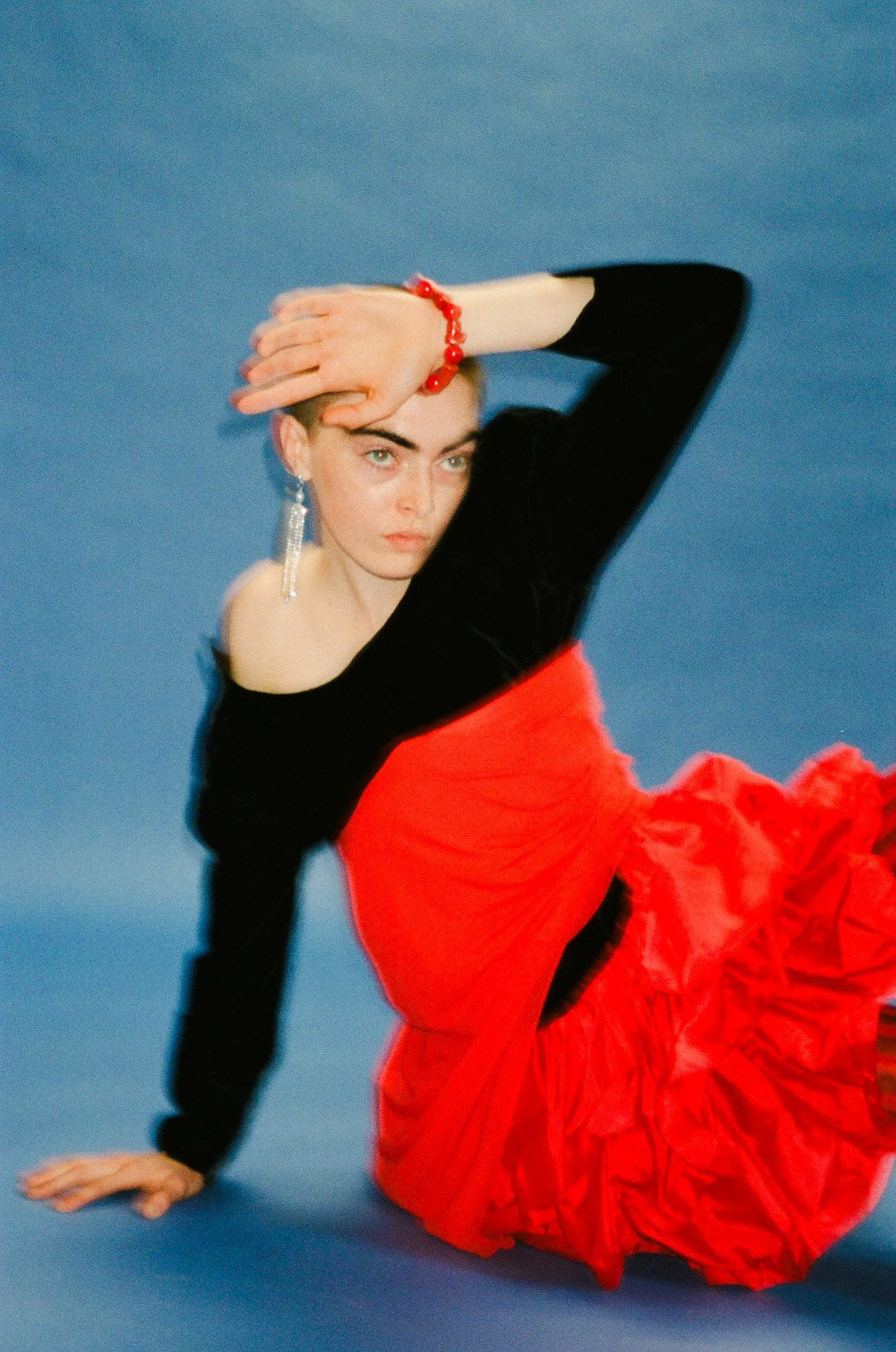 Shane Stevens wears custom designs including luxury jewelry &  accessories for gritty movement inspired campaign shot on film by NYC fashion photographer duo Indie Studios on colorful backdrop with primary color set design & creative direction
