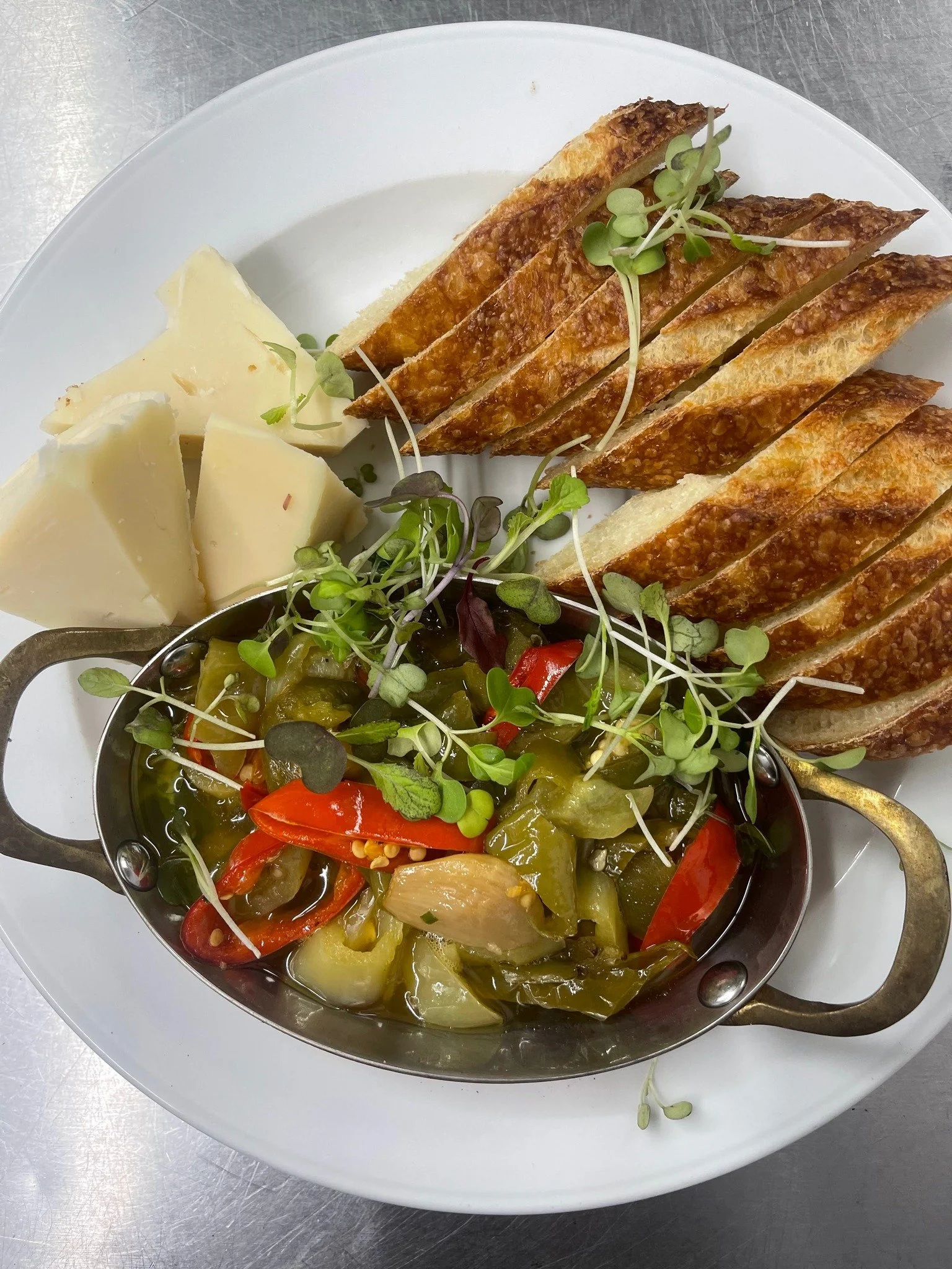 Every meal should start with an appetizer! 🧀🥖 The perfect pairing of fresh baguette, artisan cheese, and a medley of peppers &amp; onions.