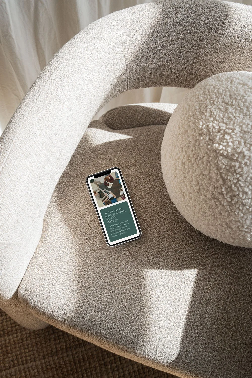 Coaching website squarespace redesign - shown on iphone on chair