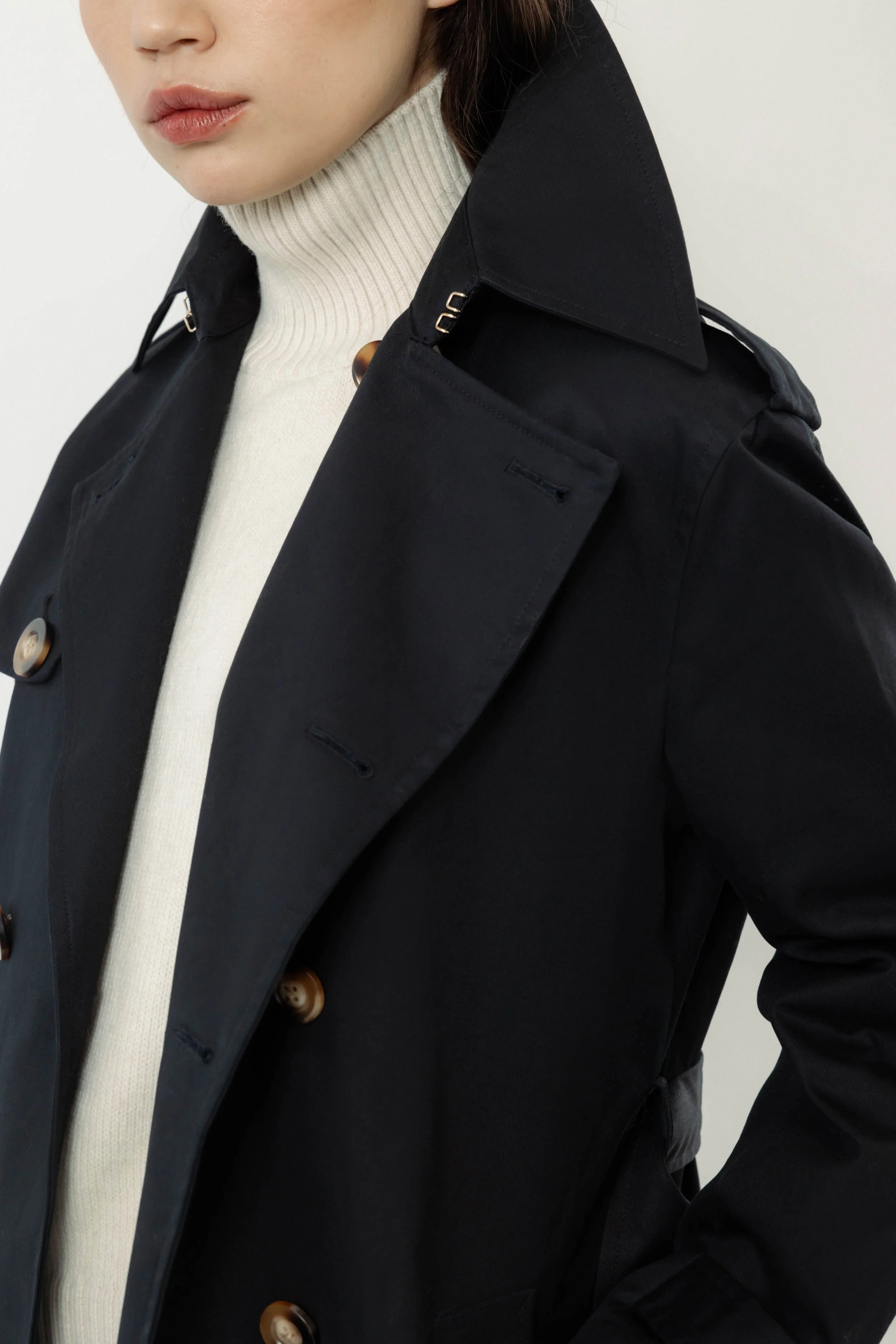 Close-up of Roz x Heather Lynn navy organic cotton trench coat, collar and belt details