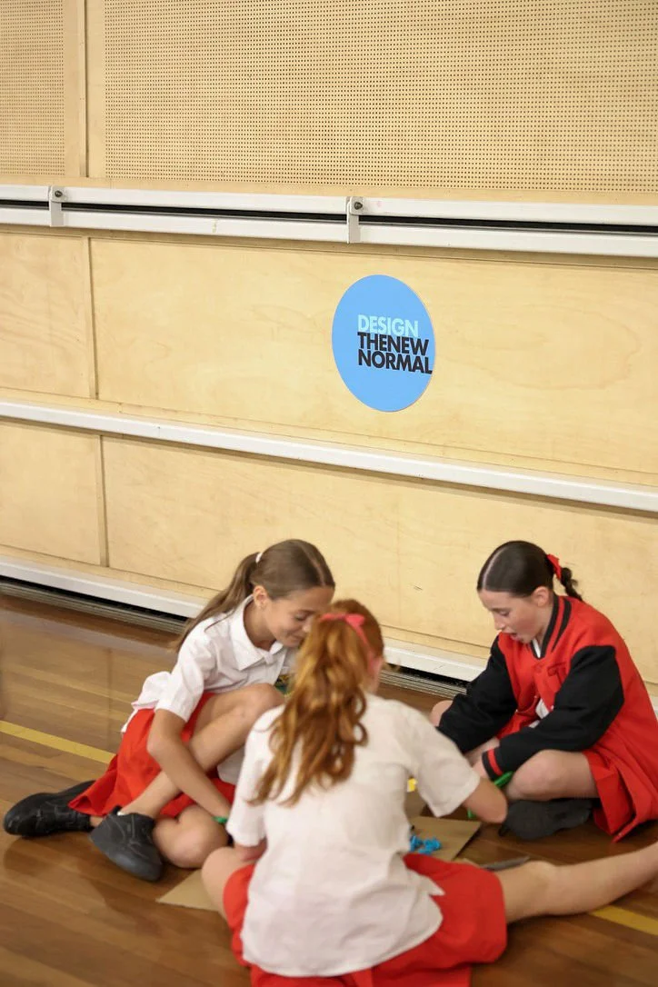 three students creating a cardboard prototype