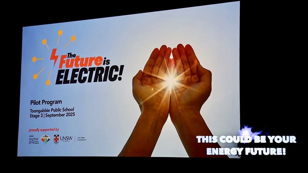 The Future Is Electric signage with a 'This could be your energy future' hologram in front