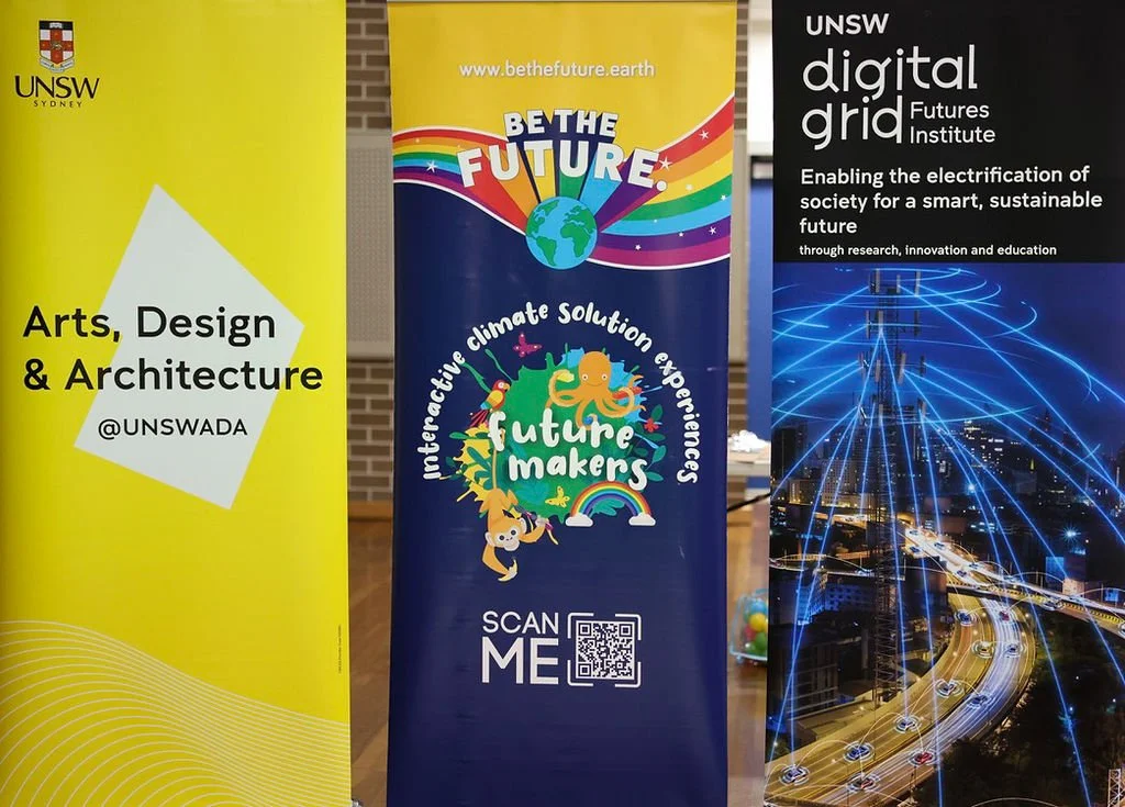 three signs including UNSW Arts, Design and Architecture, Be The Future and UNSW Digital Grid Futures Institute