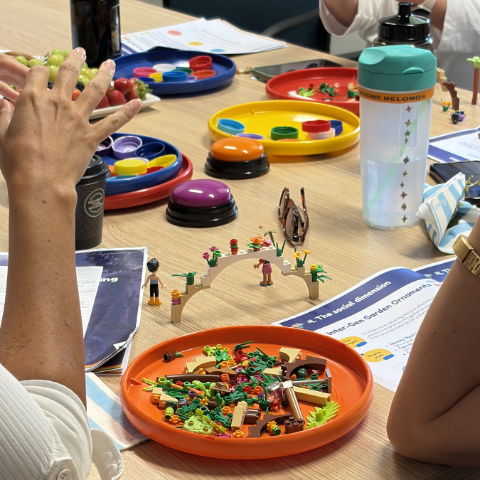 Table with lego, buzzer and bottle lids activities