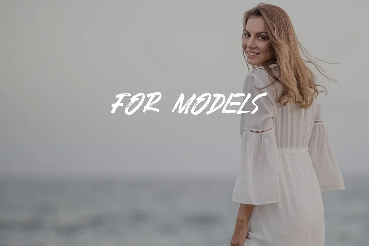 A woman in a white dress standing by the ocean with her back partially turned, smiling at the camera, with the text 'FOR MODELS' overlayed.