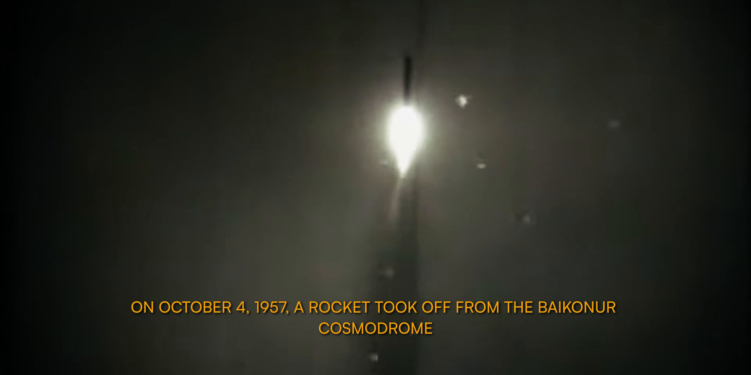 Een foto van een raket die opstijgt vanaf de Baikonur-ruimtevaartplaats, met een heldere gloed en donkere achtergrond.
