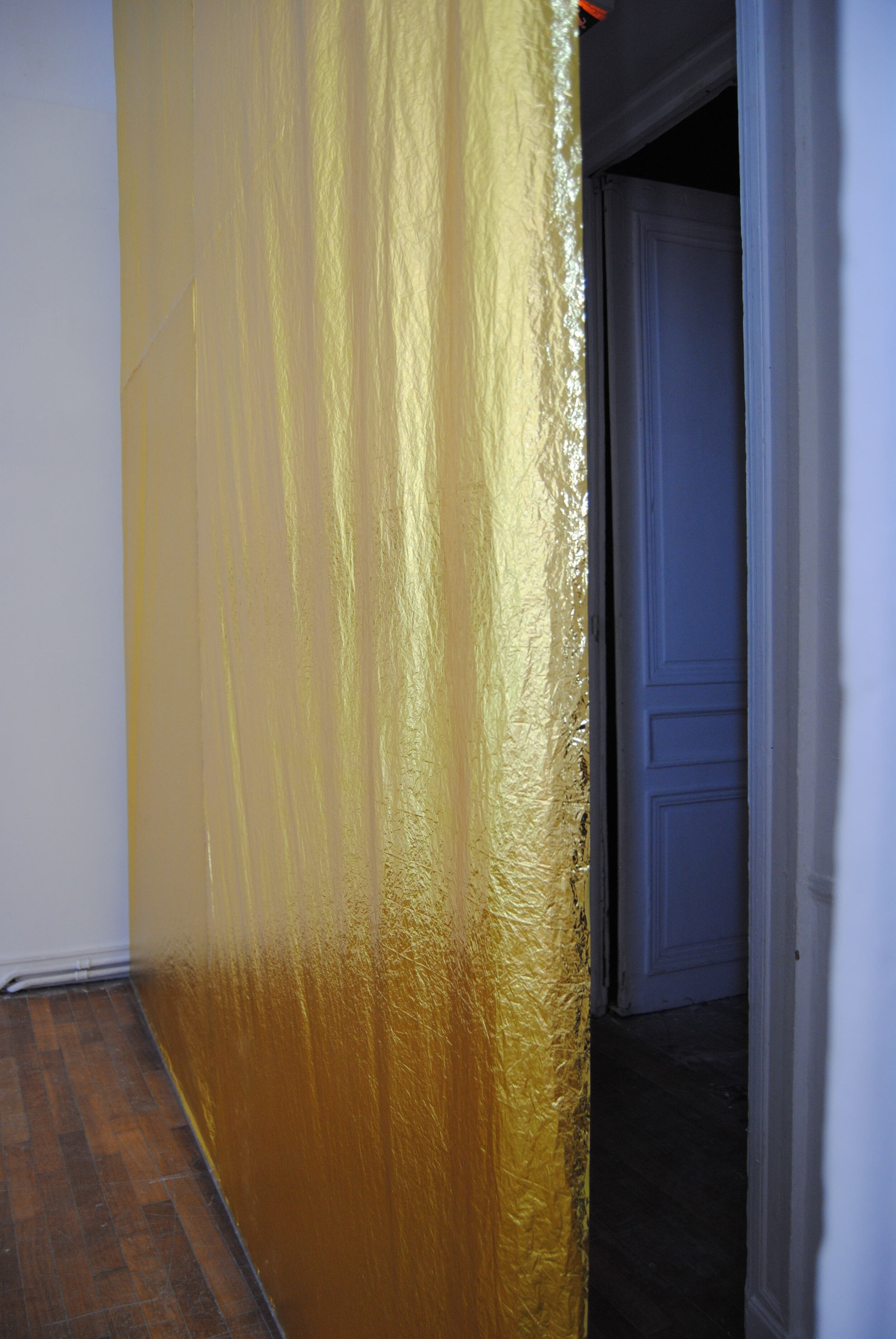 Exhibition view, artwork Transition by Judith Roux. Golden survival blanket hanging from ceiling, detail of the installation.