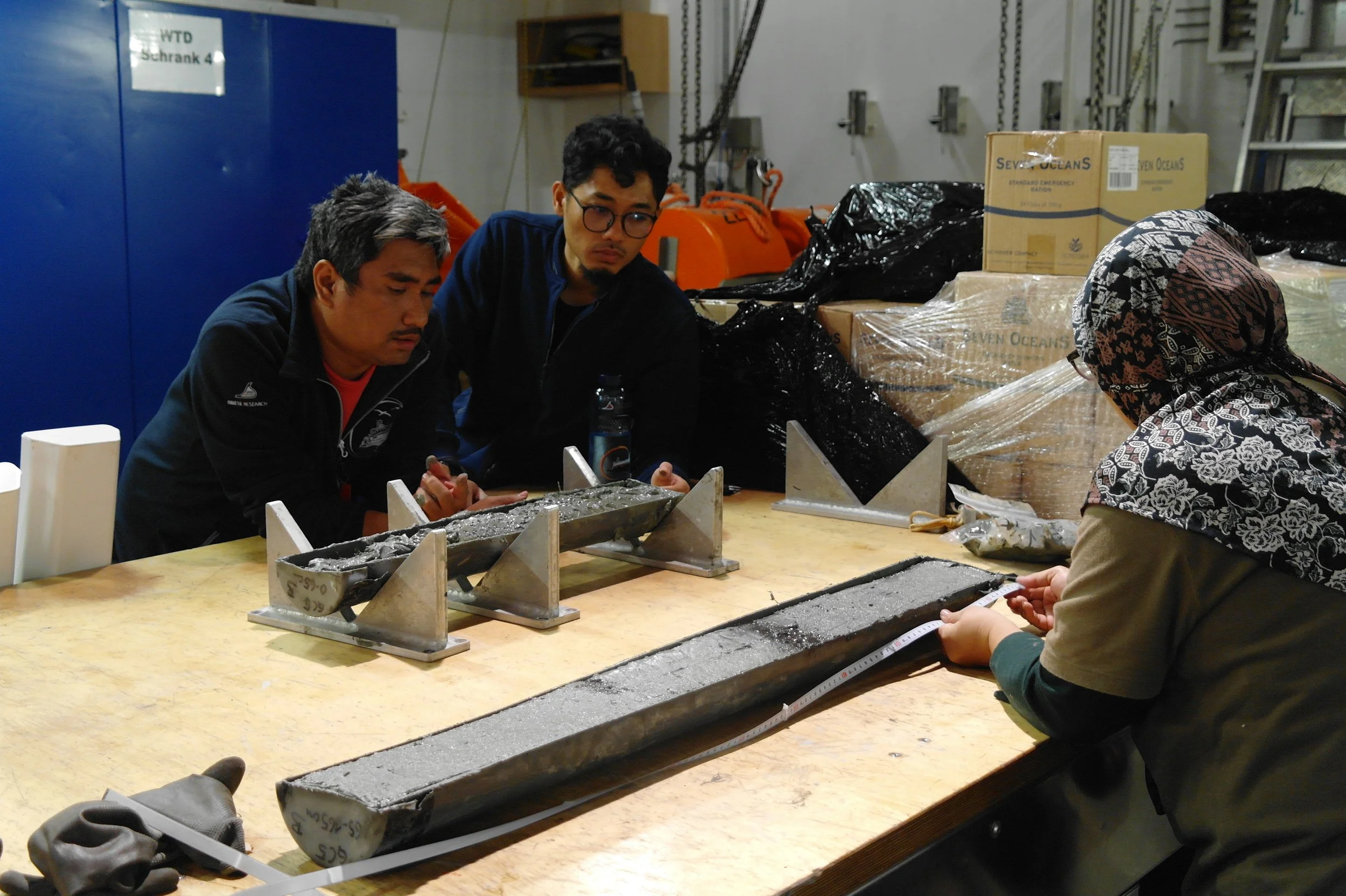  Inspecting tephra layers in the sediment gravity cores (Photo Séverine Furst) 