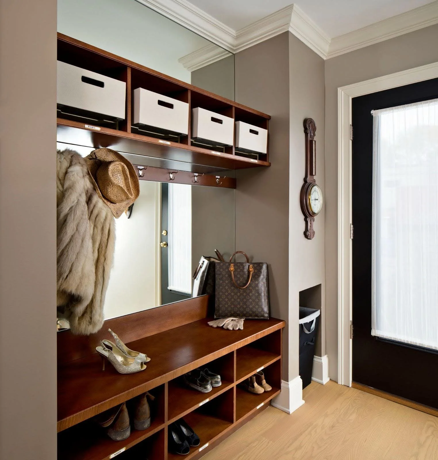 A luxury custom mudroom in the Hollywood Regency project designed for family organization, featuring high-end cabinetry and storage for school gear.
