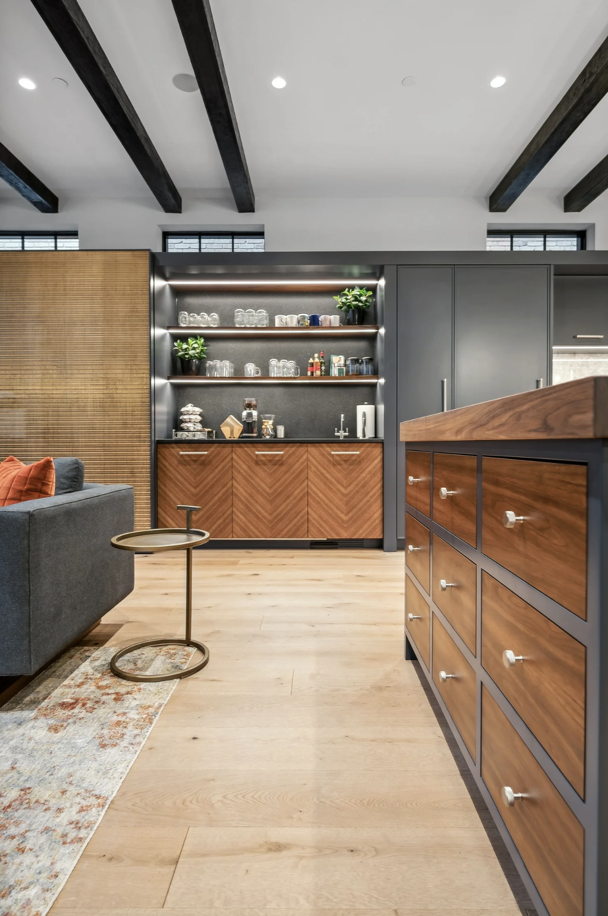 Modern interior design using geometric wood veneer patterns in architectural millwork.