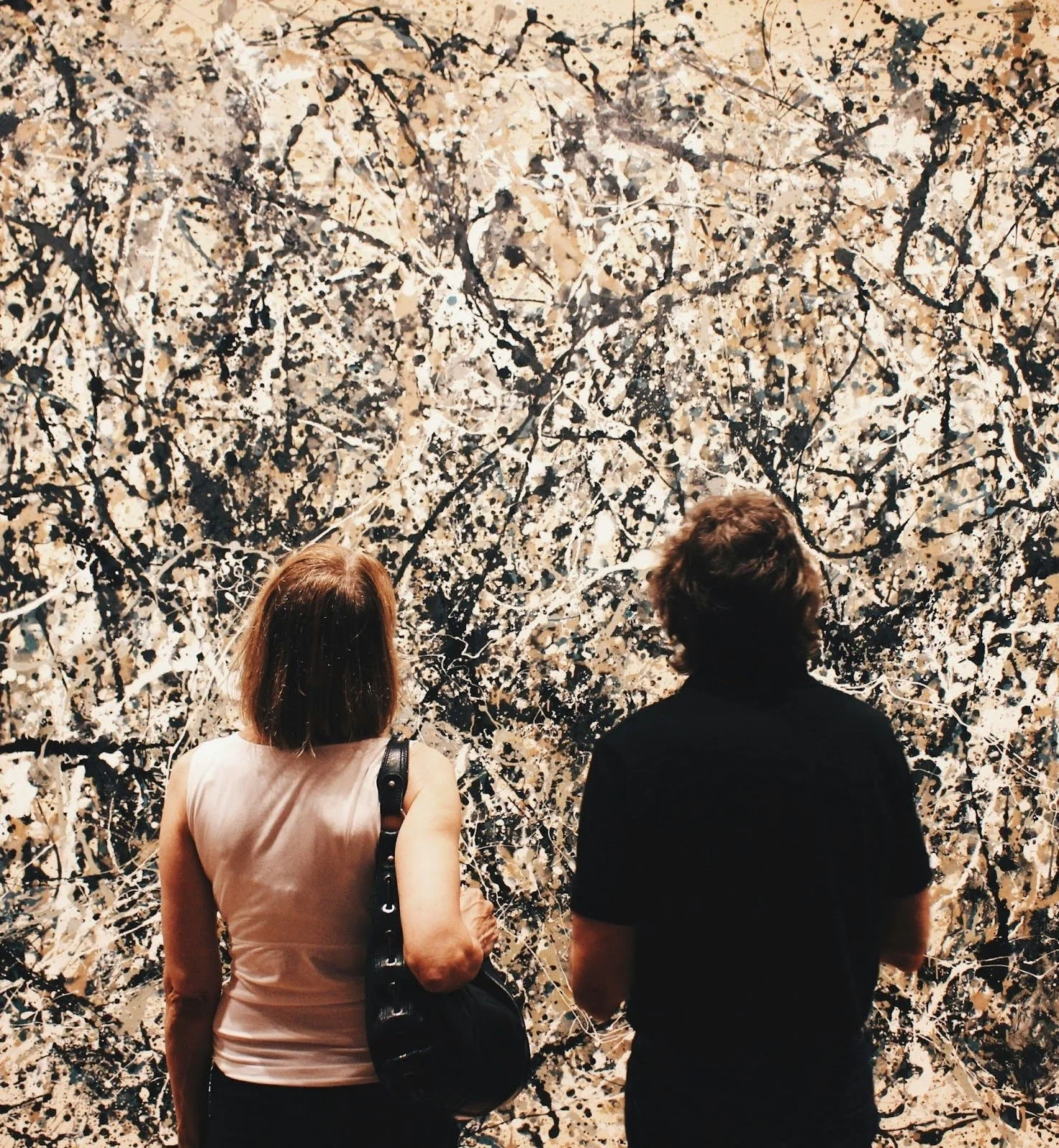 two people seeing a large piece of art