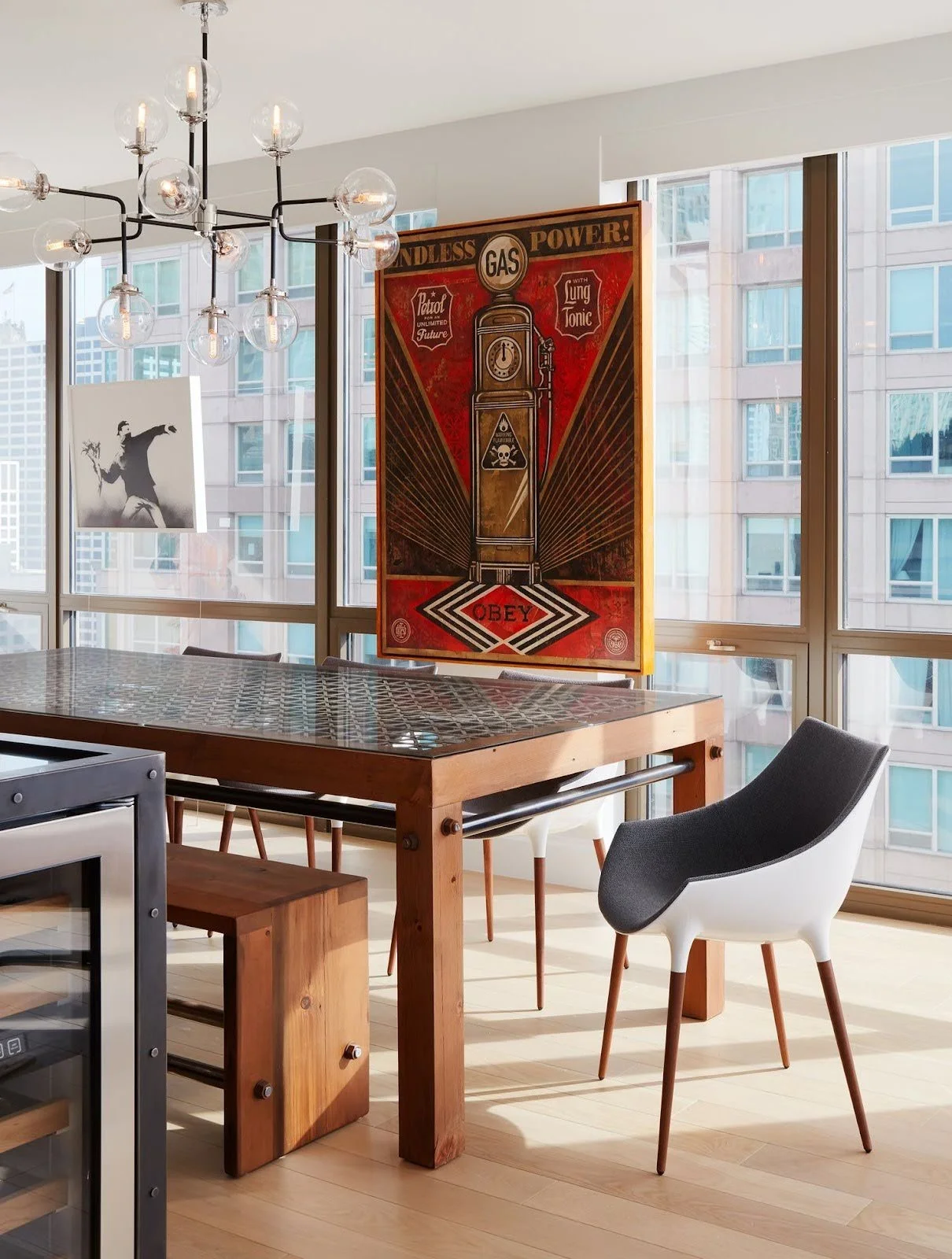 An example of the art of choosing art: a large-scale painting positioned to complement a modern urban dining room's and luxury finishes.