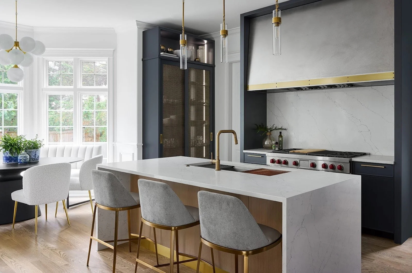 A cozy kitchen study nook with a built-in banquette at the California Farm House project, allowing parents to supervise homework while prepping meals.