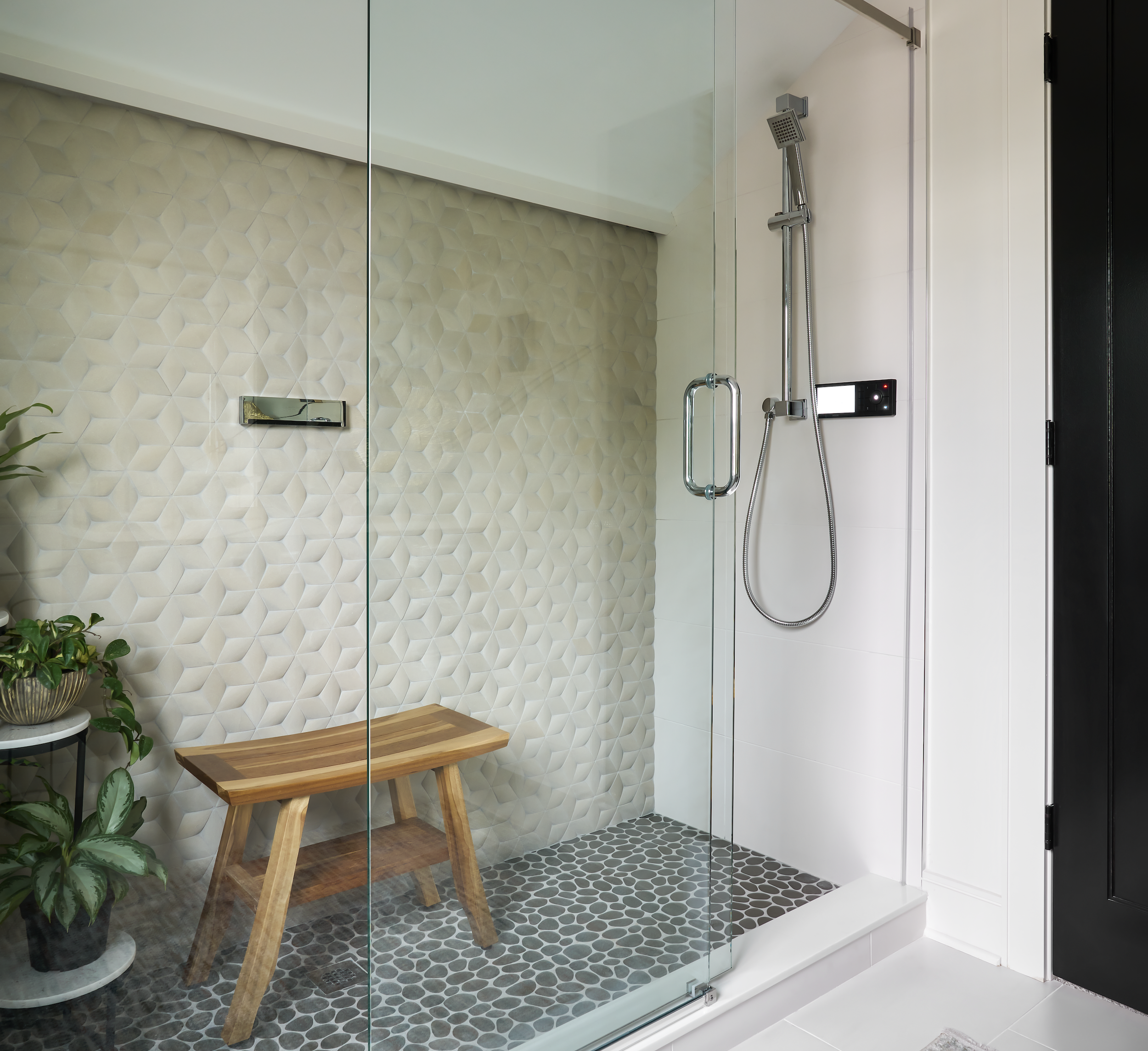 Serene attic spa bathroom for a 'lady’s lounge' featuring textured geometric sandstone wall tiles and a glass pebble mosaic floor.