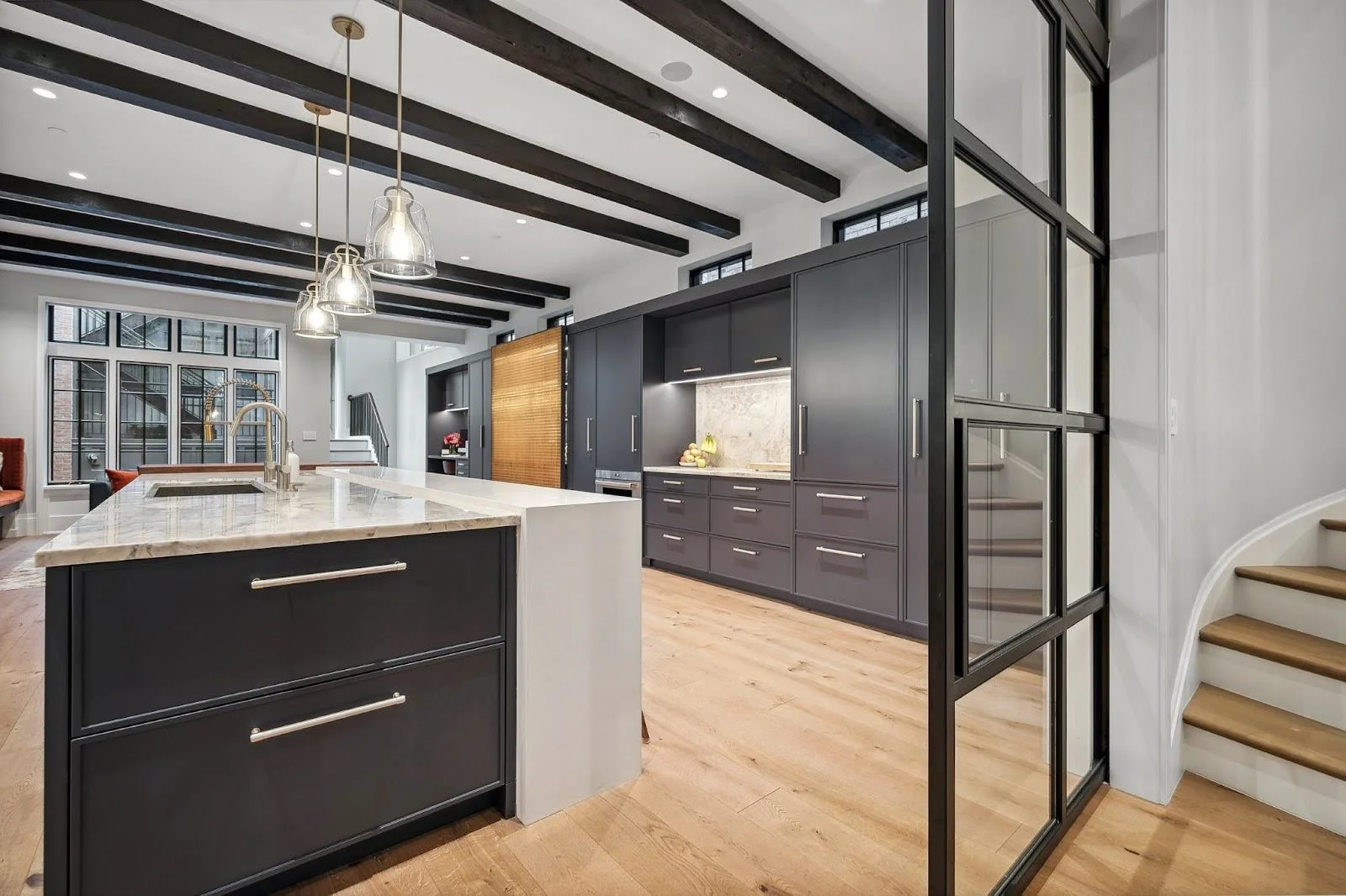 Modern living room in Lincoln Park featuring moody, architectural charred faux wood beams stretching across the ceiling for a textured, rebel feel.