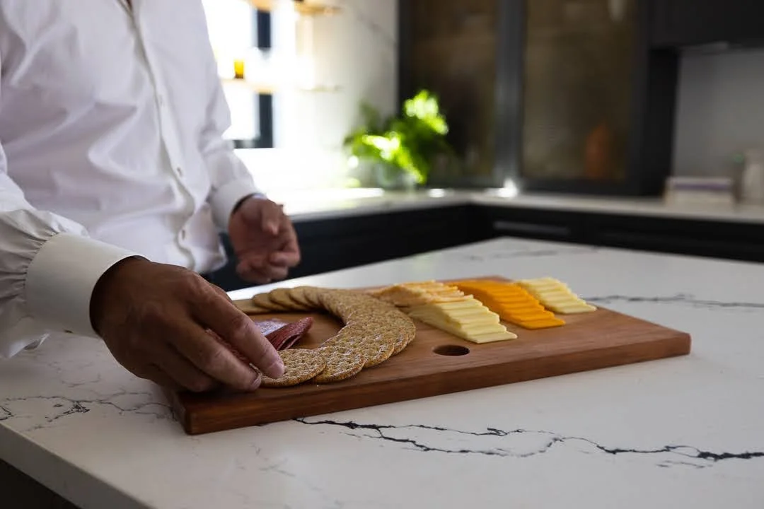 A modern kitchen with a marble countertop snack station designed for easy after-school access in a luxury family home.