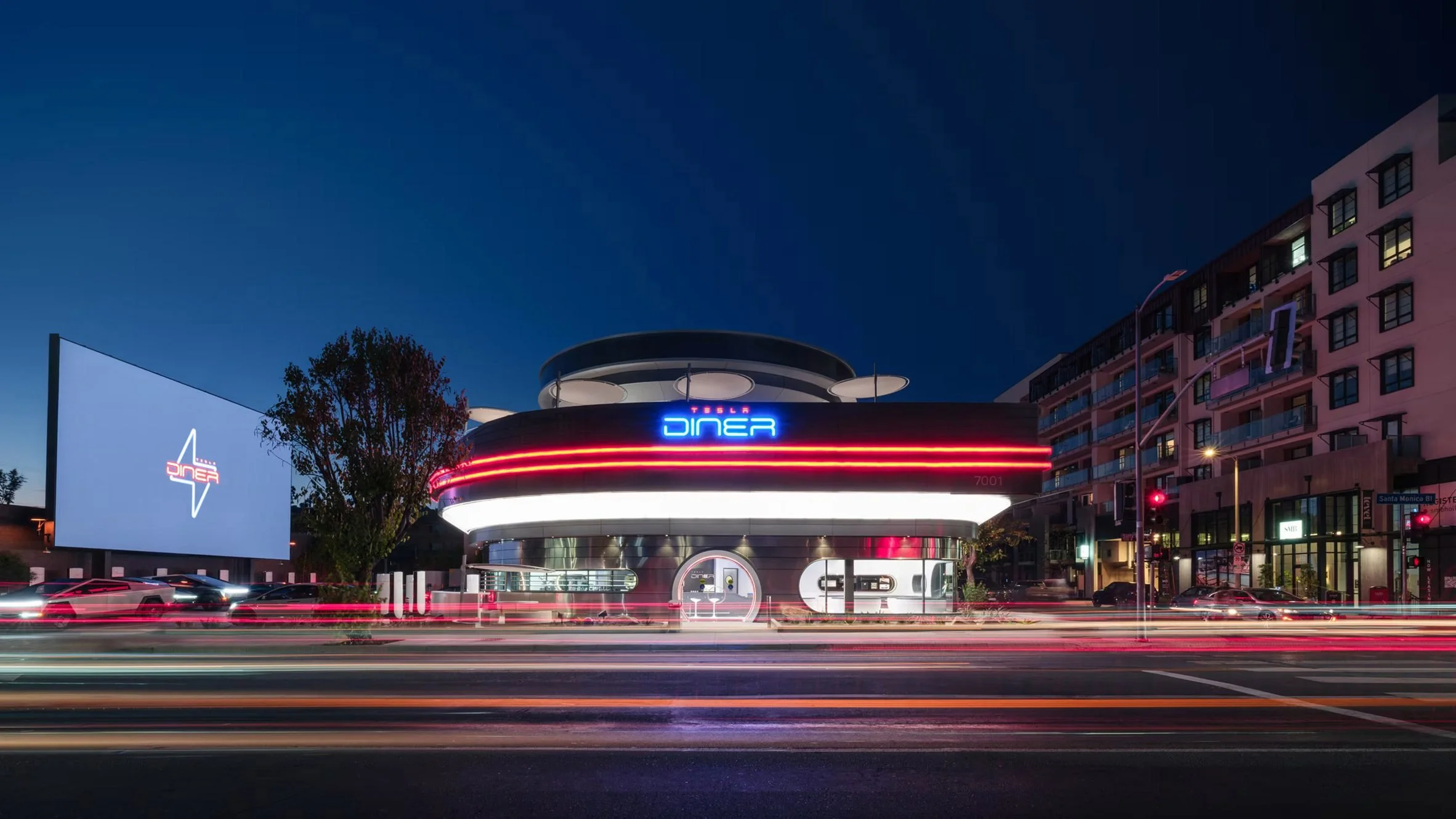 Tesla Hollywood diner showcasing retro-futuristic architecture with clean modernist lines, integrated EV charging, and an experiential design environment