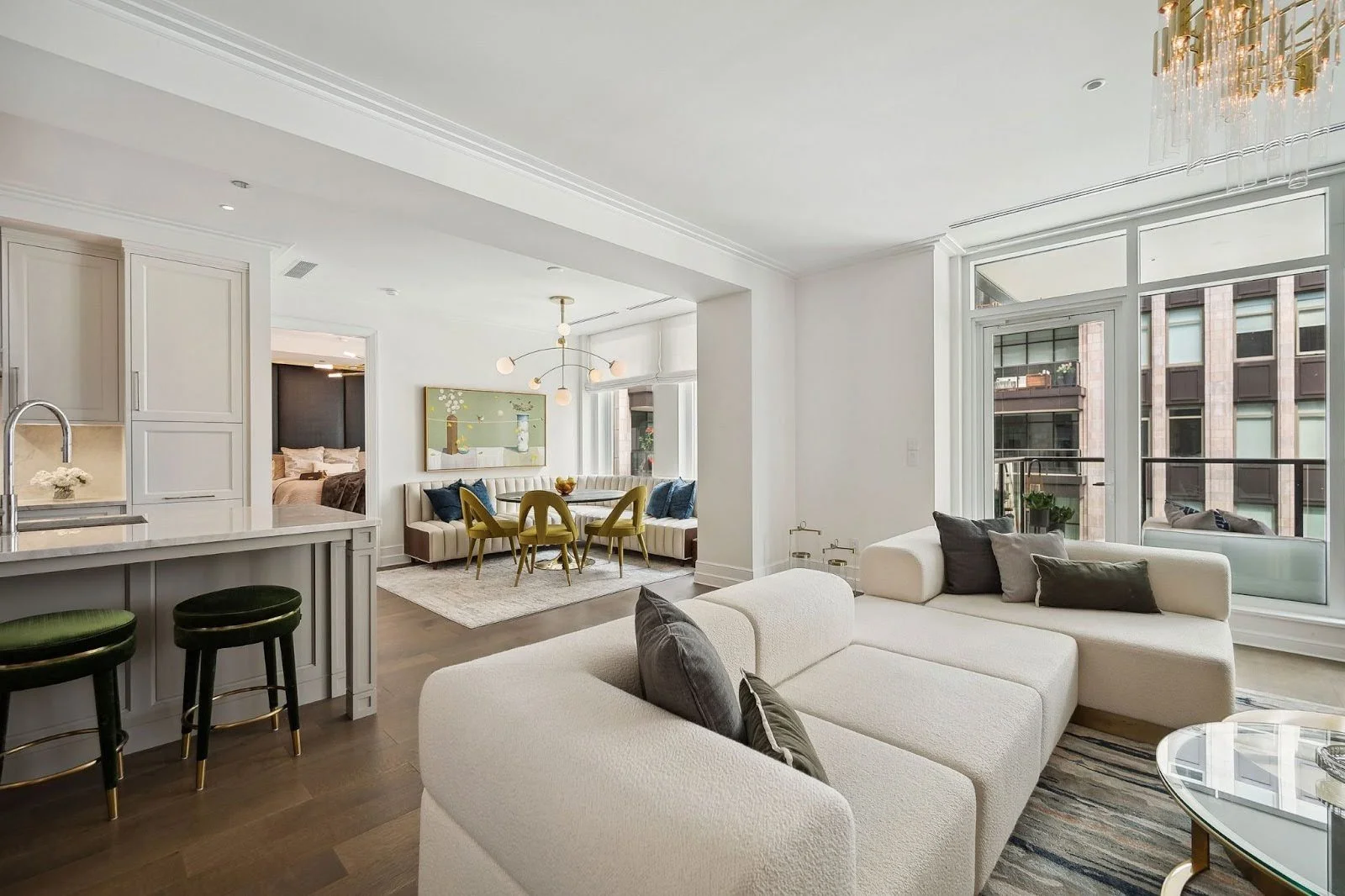 Main living space in the Tribune Tower Elegance project featuring a convertible sofa and an informal dining area to maximize social flow.
