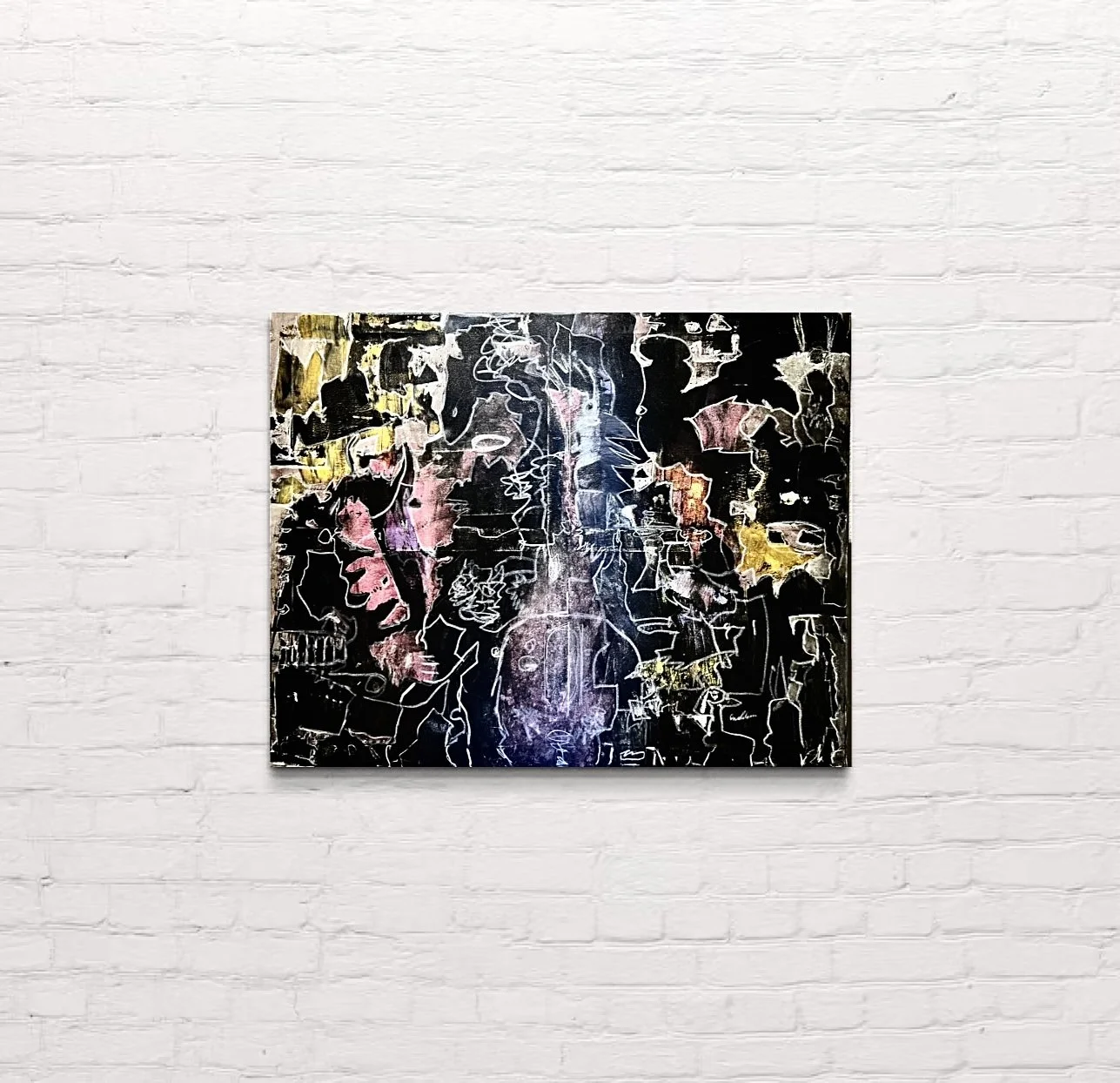 Une peinture de la collection UED exposée sur un mur de briques blanches.