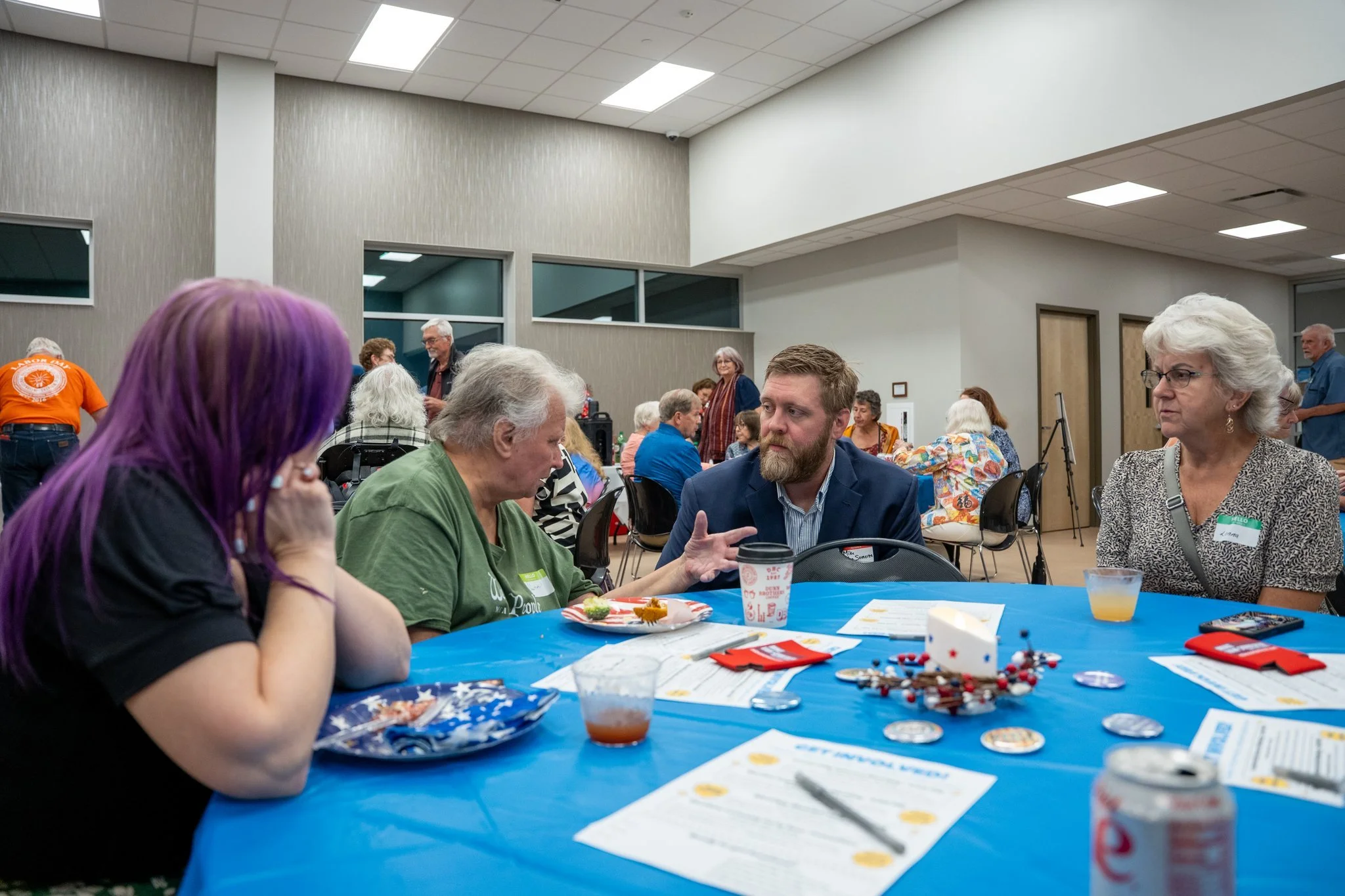 Mike Van Someren speaking with community members at a democratic party event.