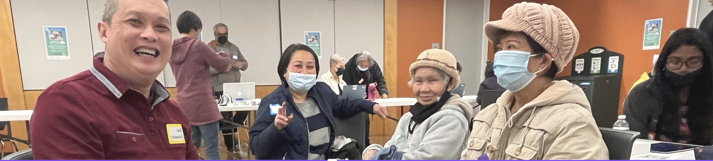 Three older adults and one digital navigator at a Tech Support Popup at SF Public Library