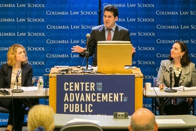 Gabriel Kuris stands at a podium speaking during a panel at Columbia Law School.