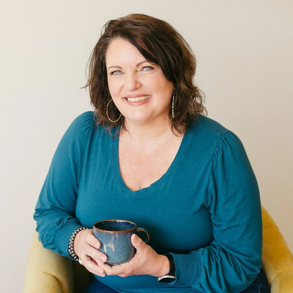 Aurelie holding a cup of chai tea and smiling