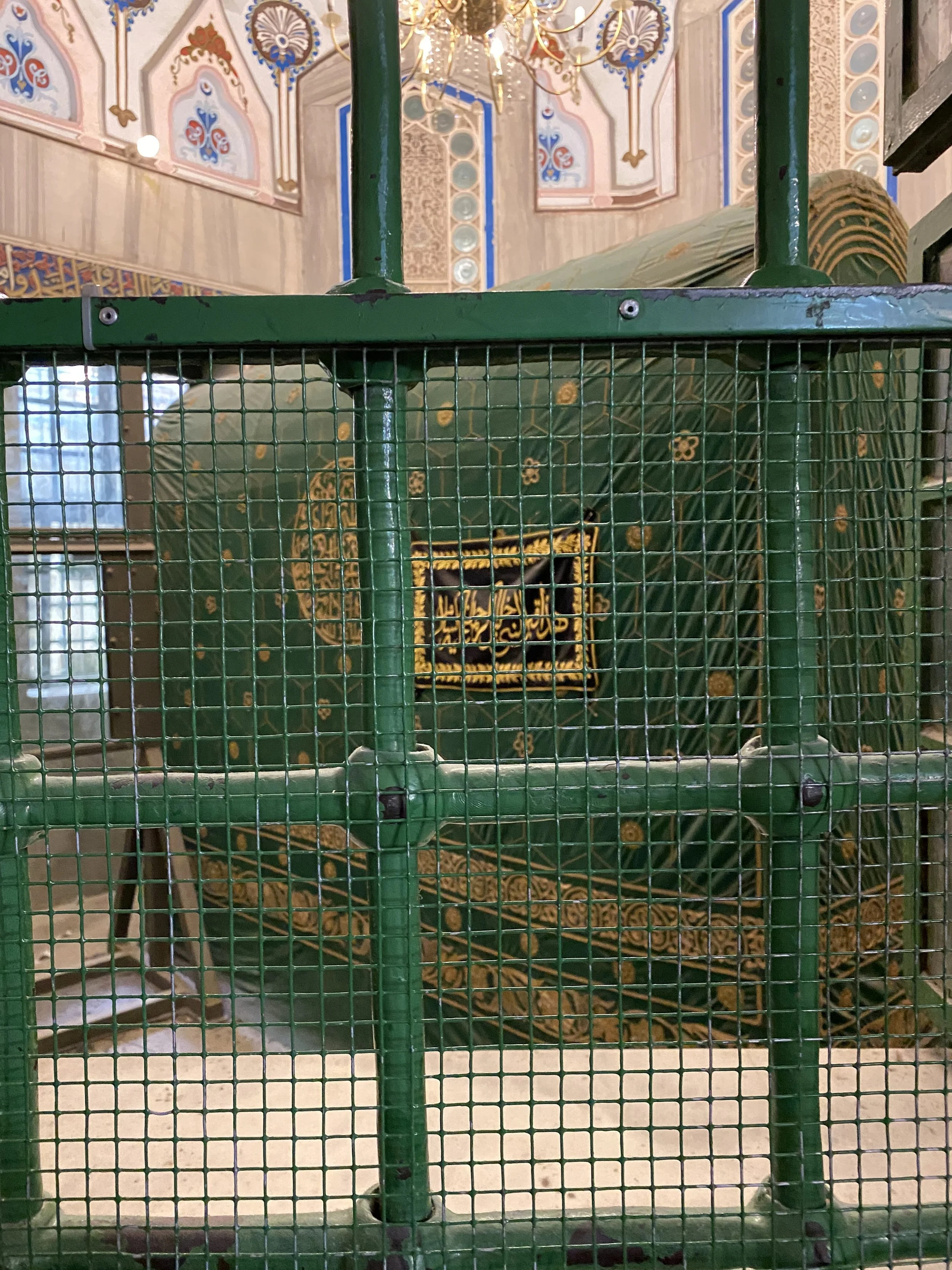 Viewing the cenotaphs of Abraham and Sarah between the Mosque and Synagogue.  Protected by bars.