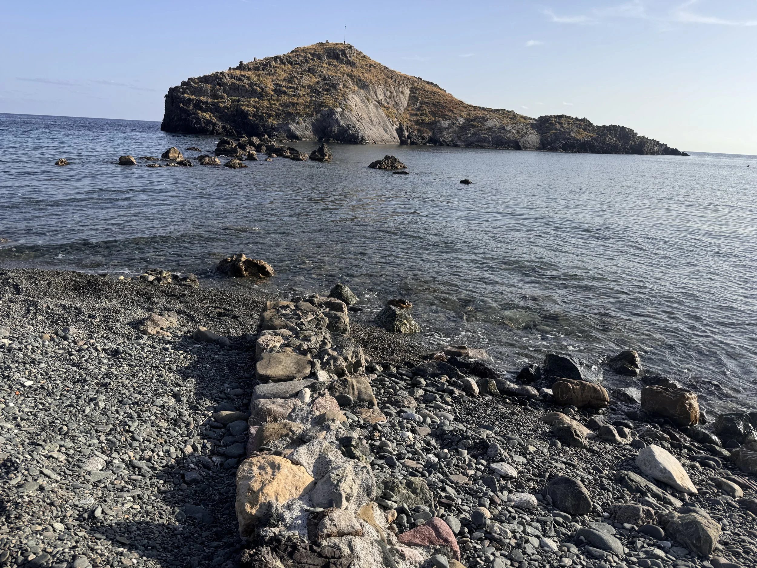 ancient (Minoan era through roman) mole in the harbor between the shore and the little island of Trafos