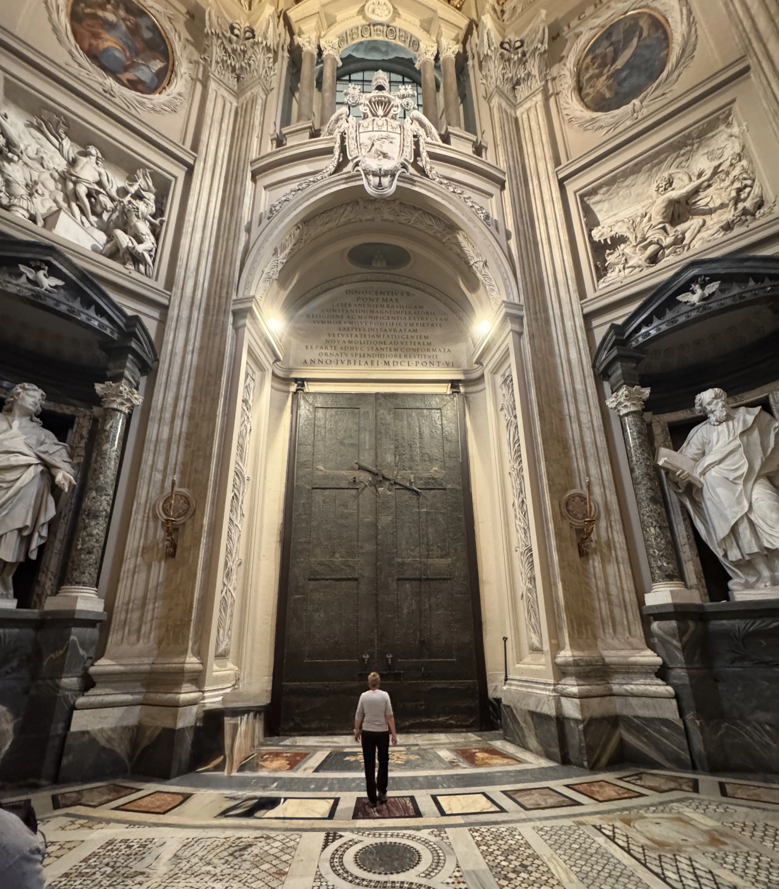 Shelly standing in front of one of the massive doors at San Giovanni in Laterano