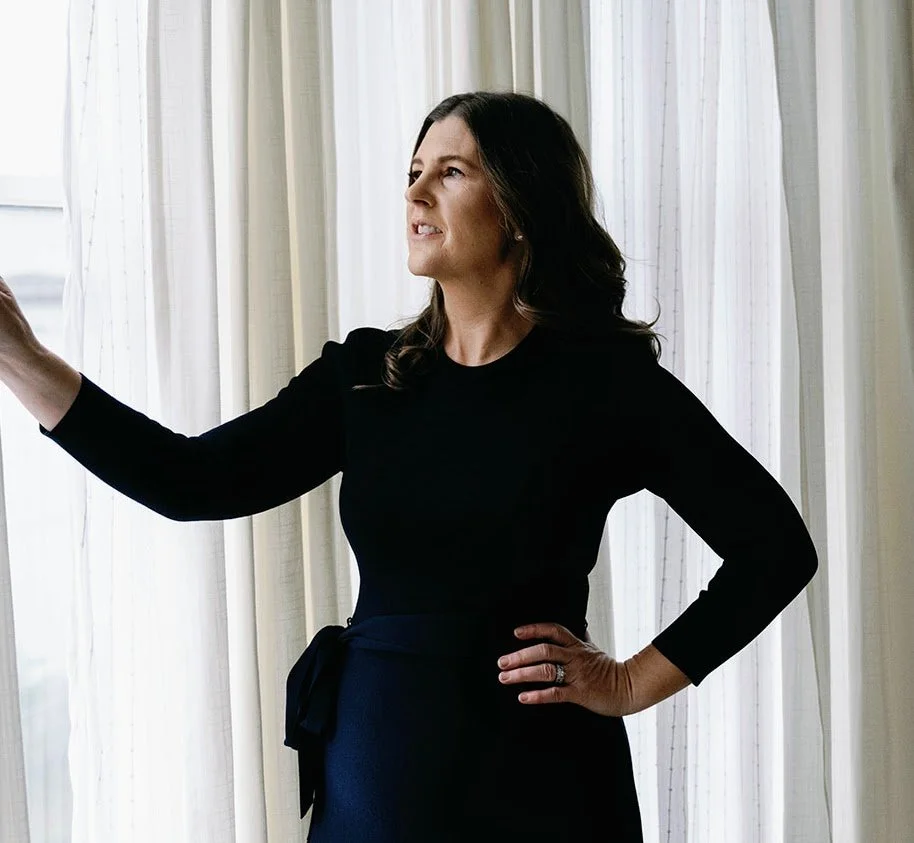 Katherine Libonate standing by a sunlit window