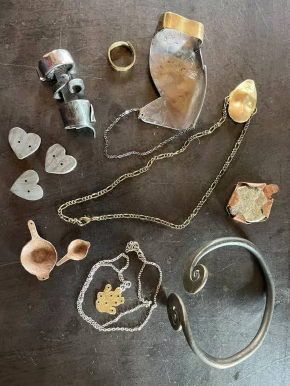  Hand brace, rings, pendants and buttons by Lili Jones. 