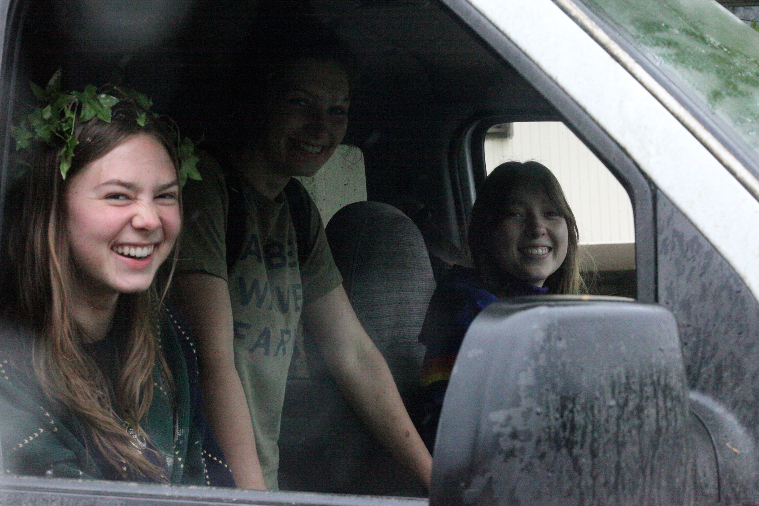 Neko Heinrich, Phoebe Weignberg and Eleanor Sanford smile from the Maintenance van