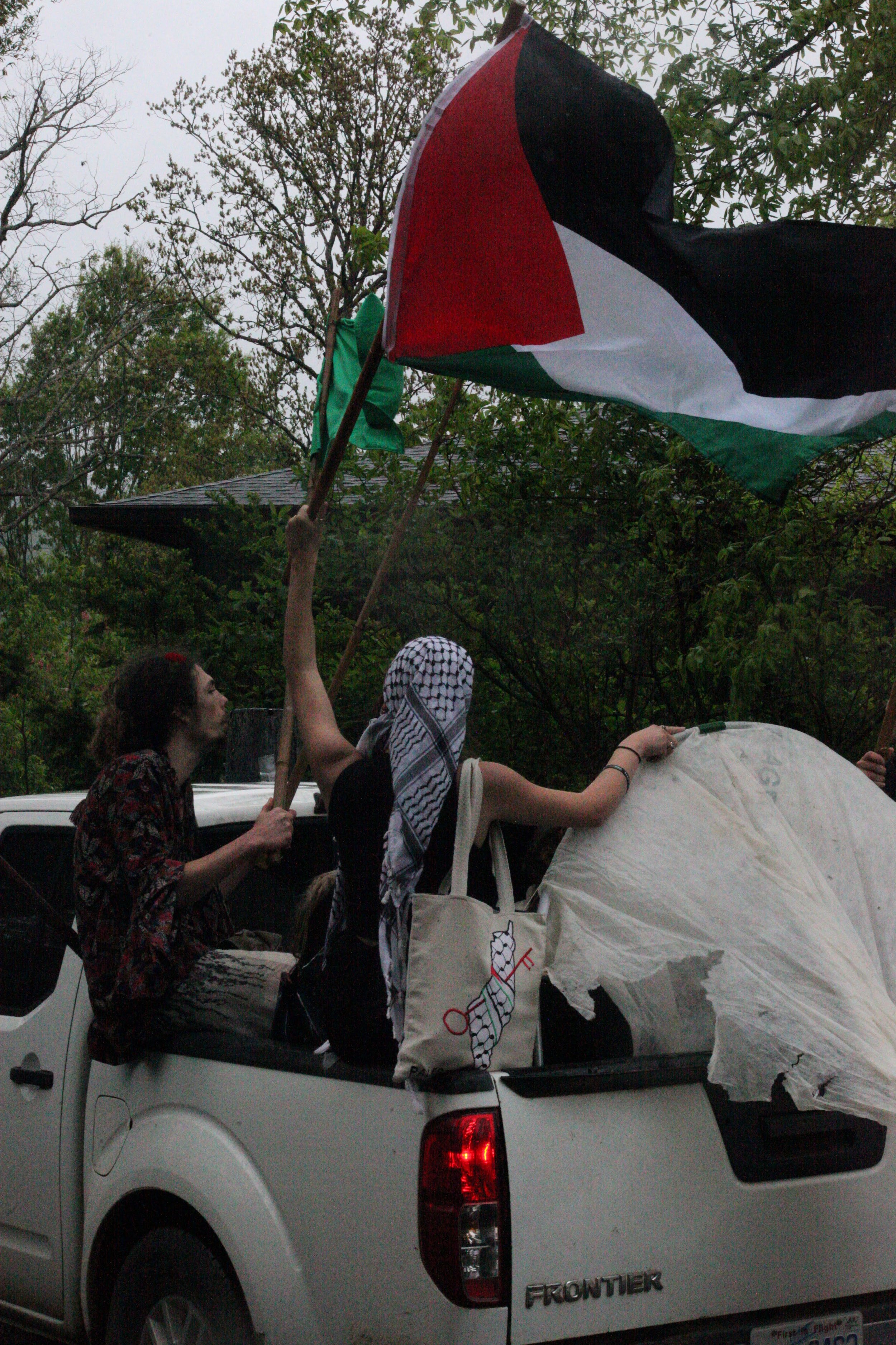 Mia Thompson waves the Palestinian flag