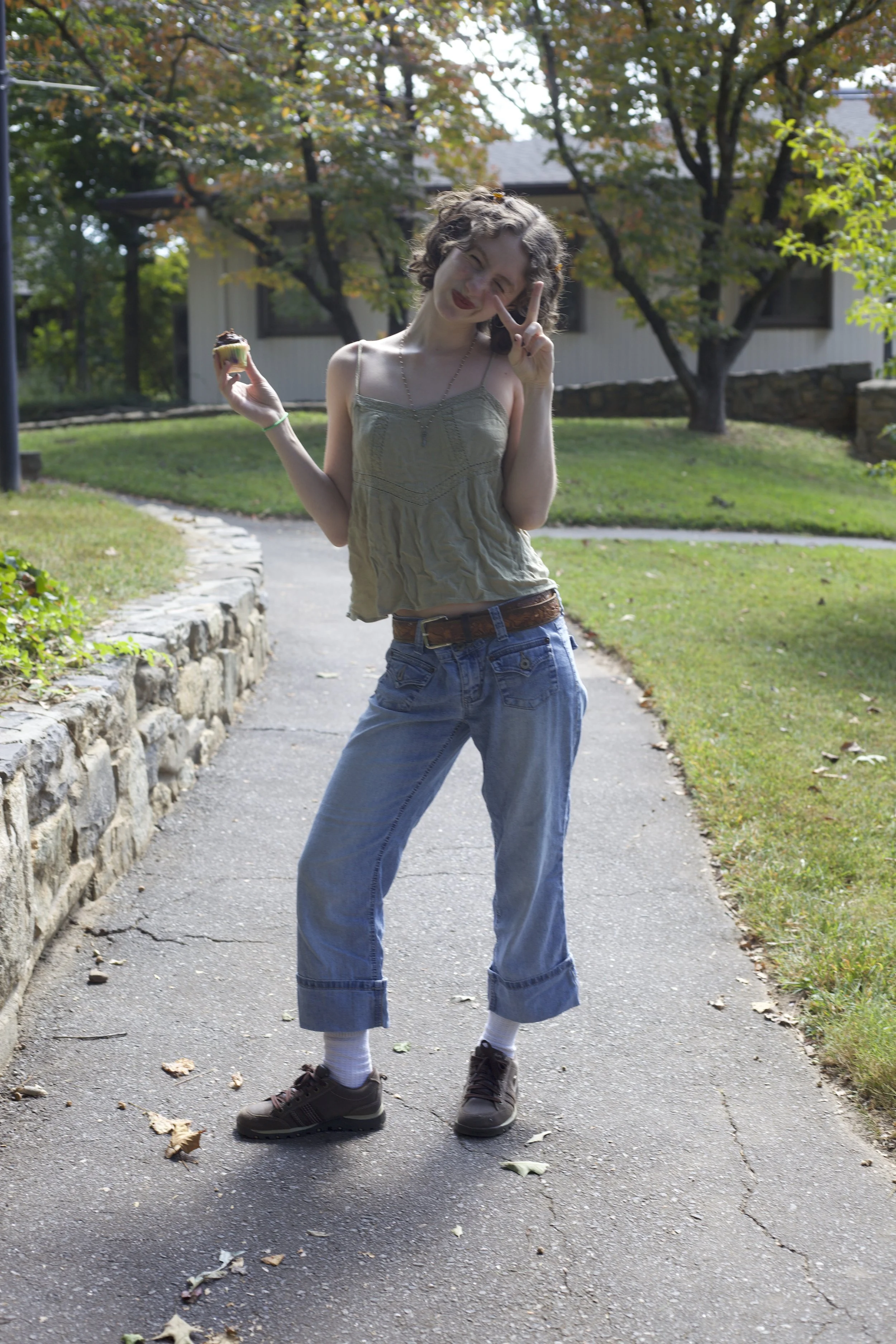 Ray Schwartz with a delicate beaded necklace, cuffed jeans and a cupcake.