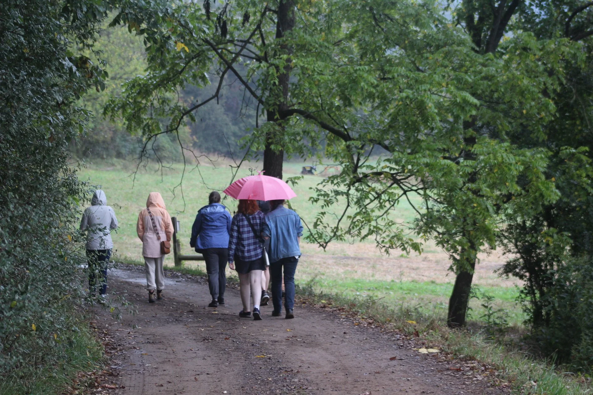  A group of community members walks the farm loop down to the Swannanoa River for communal reflection a year after Hurricane Helene at Warren Wilson College in Swannanoa, N.C., on Sept. 26. (Vivian Bryan/The Echo) 