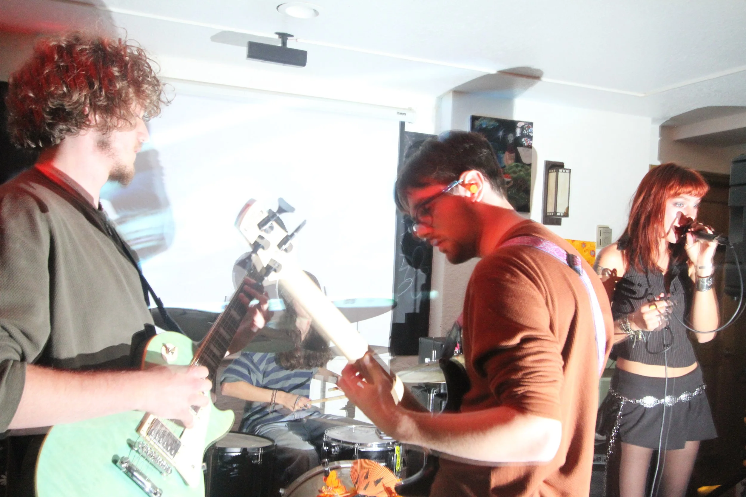  The band Hard Cider, featuring sophomores  Zach Levis  on guitar,  Maddie Gamache  on drums, and singer  Mikayla Stanek , performs their set at Sage Cafe in Swannanoa, N.C., on Oct. 25, 2025. 