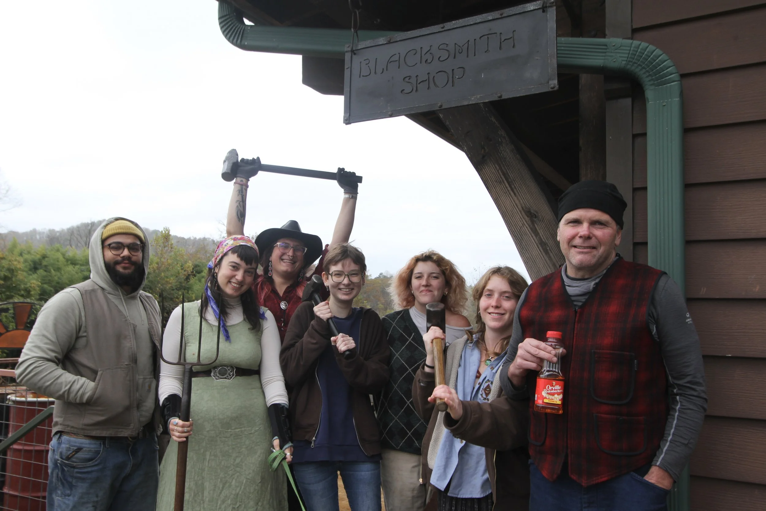  Members of the Warren Wilson College (WWC) Blacksmith Crew pose for a group photo in front of the forge on Oct. 28, 2025, in Swannanoa, N.C. (Echo/Vivian Bryan) 