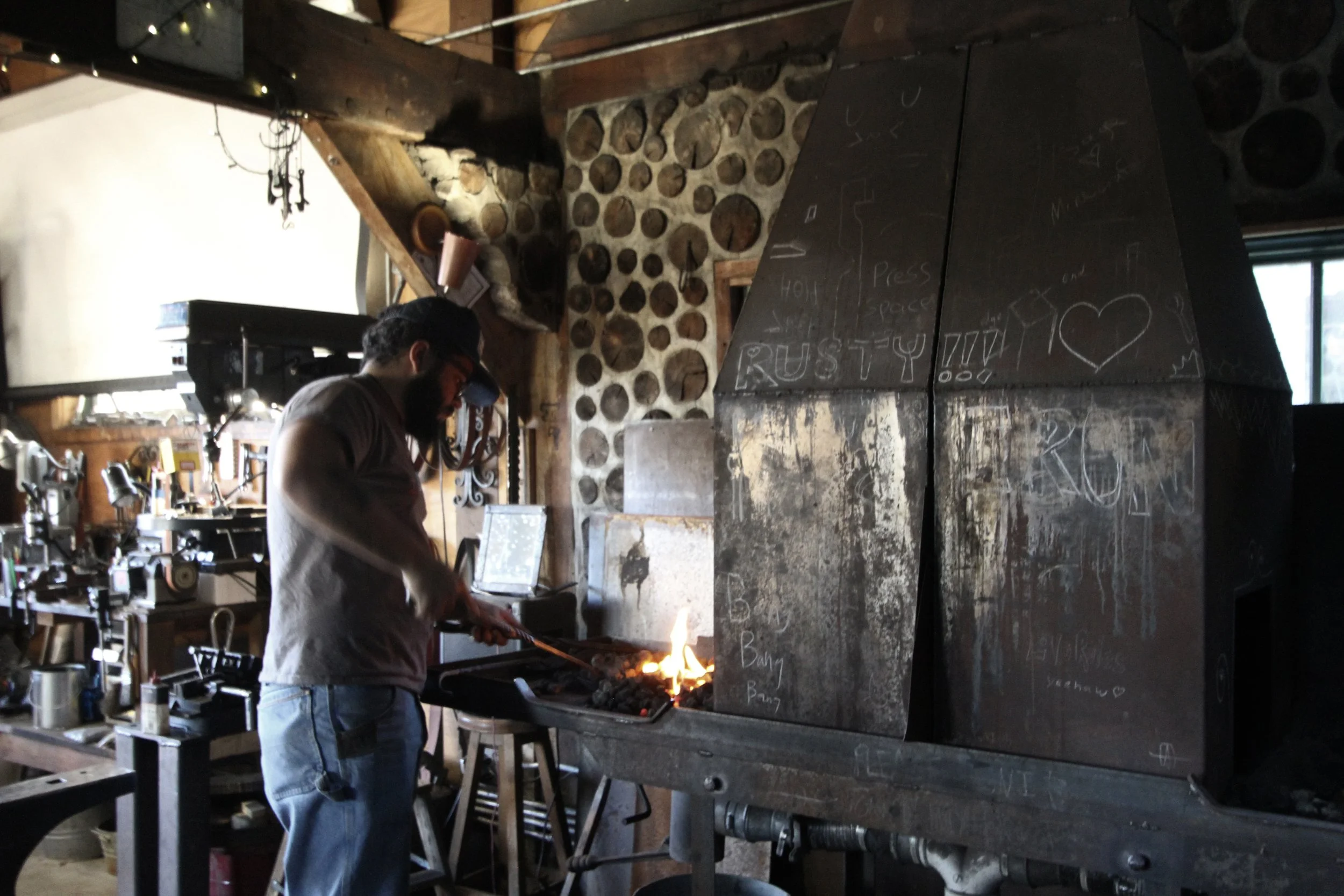  Freshman crew member  Henry Scoggins  forges scrolls for the feet of a coat rack in the forge on Nov. 4, 2025, in Swannanoa, N.C. 