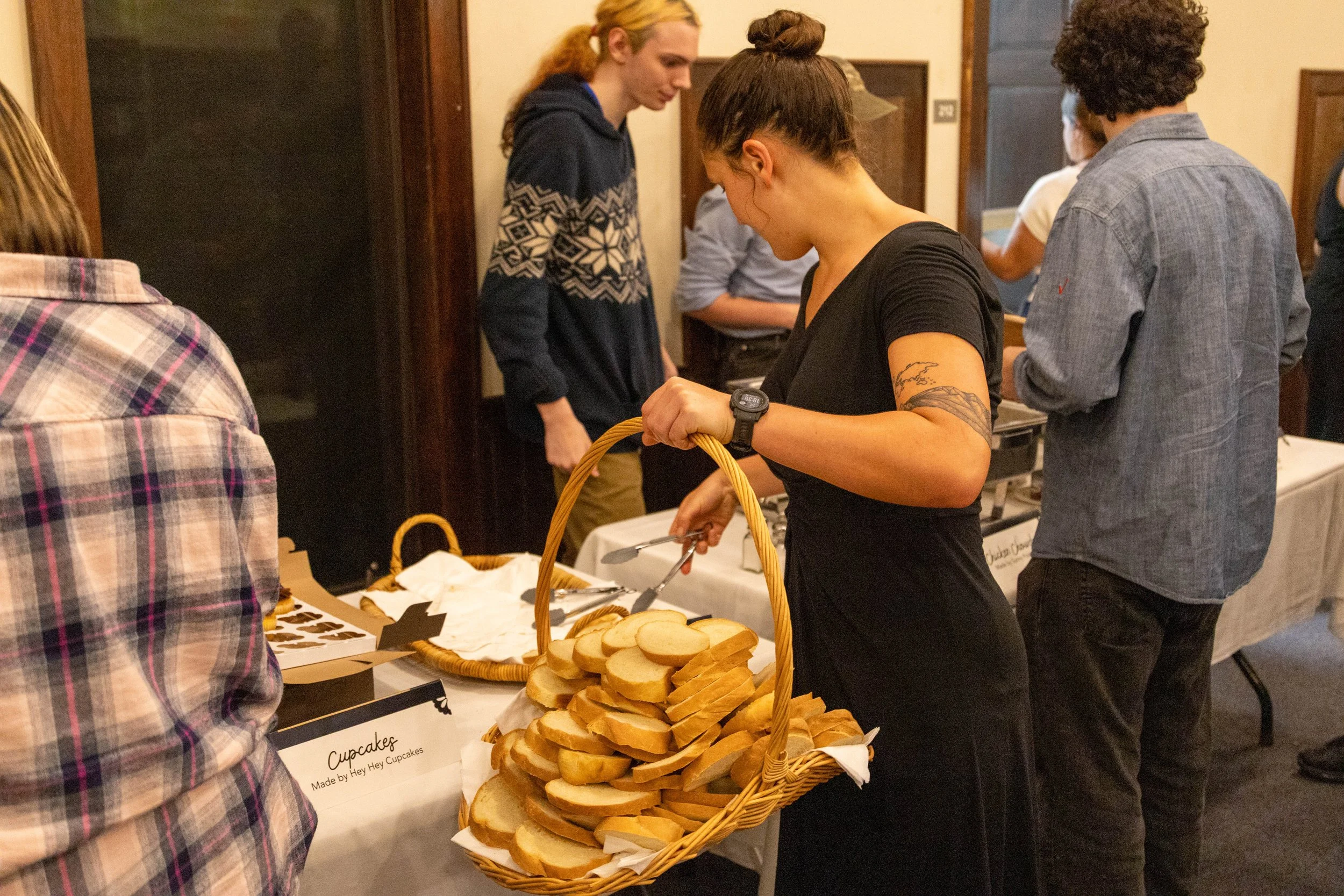  Community Engagement crew member  Elena Wheeler  sets out bread at the Warren Wilson College (WWC) Empty Bowls dinner on November 19, 2025 in Swannanoa, N.C. (Neko Heinrich/Echo) 