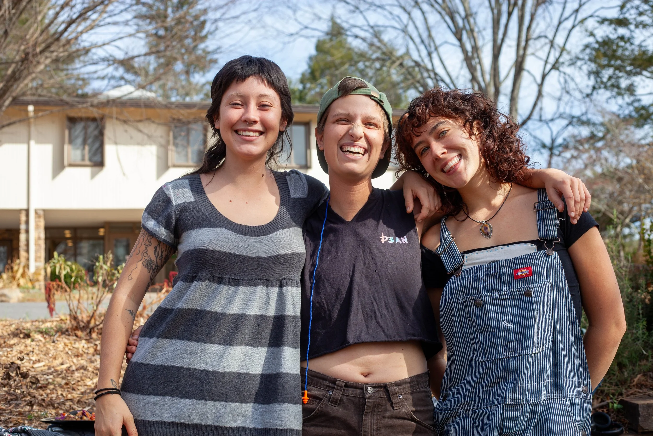   Alex Valenzuela ,  Sal Ward , and  Cecilia Moushey  pose at Warren Wilson College’s (WWC) performative masc contest in Swannanoa, N.C. on November 18, 2025. (Echo/Emma Taylor McCallum) 
