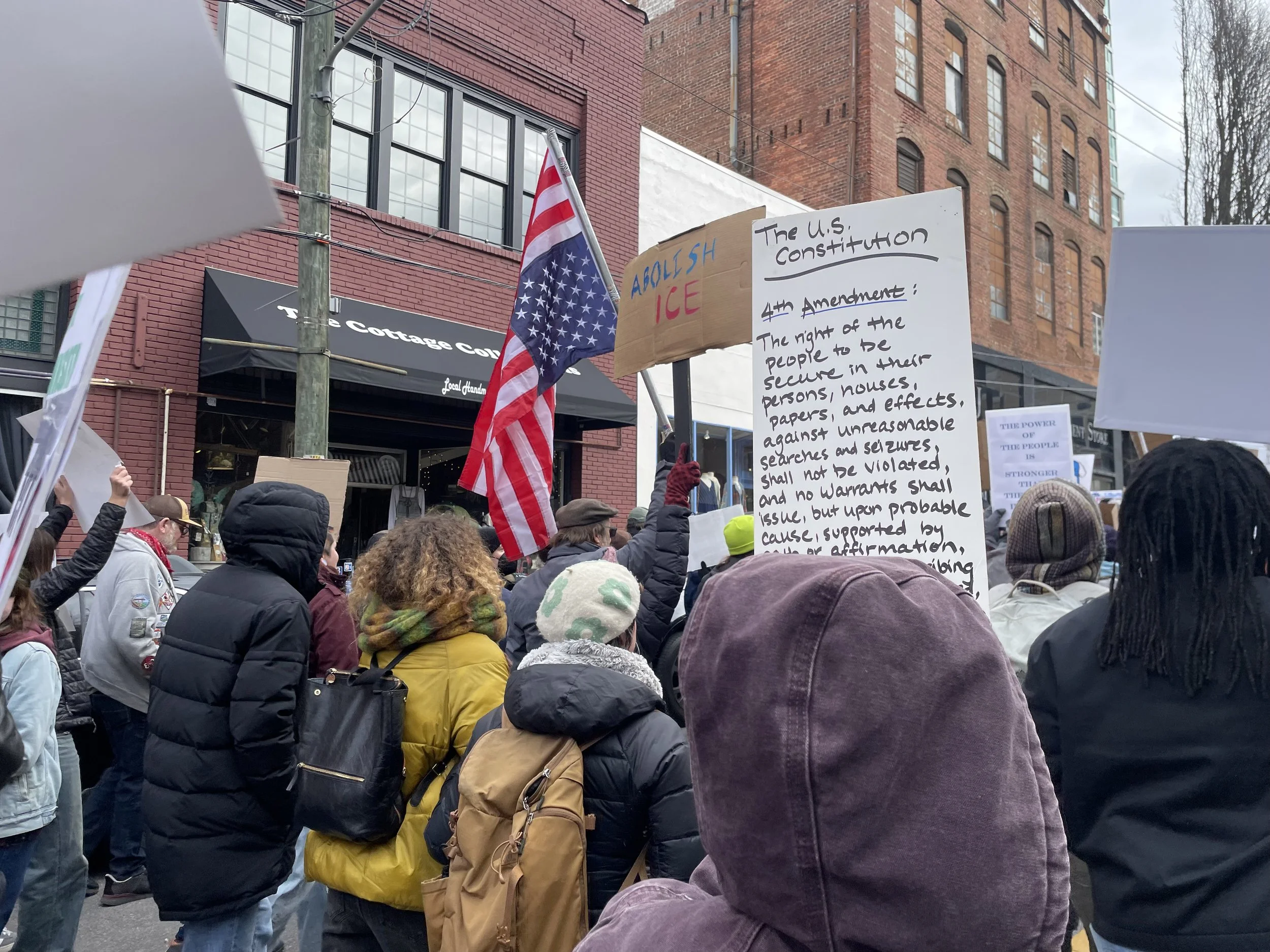     People hold signs calling for justice and peace during the national shutdown protesting recent killings by ICE, Asheville N.C. on Jan. 30, 2026. This was part of a national campaign to strike against the ICE occupation of Minneapolis. (Echo/Emma 