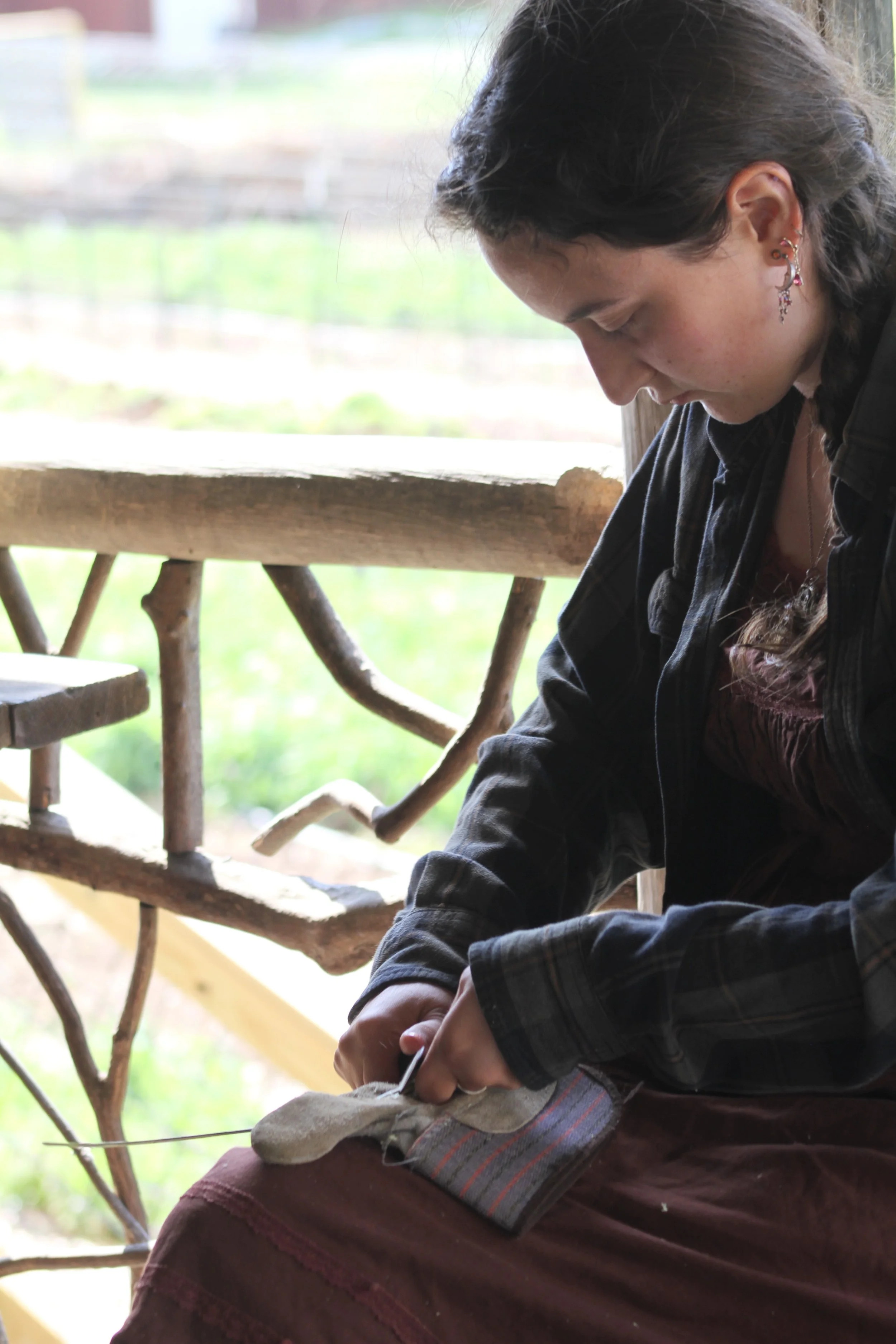  Junior Cecilia Oseguera uses hand tools to thin a river cane splint during a workshop at Warren Wilson College in Swannanoa, N.C., on March 26. (Vivian Bryan/Echo) 