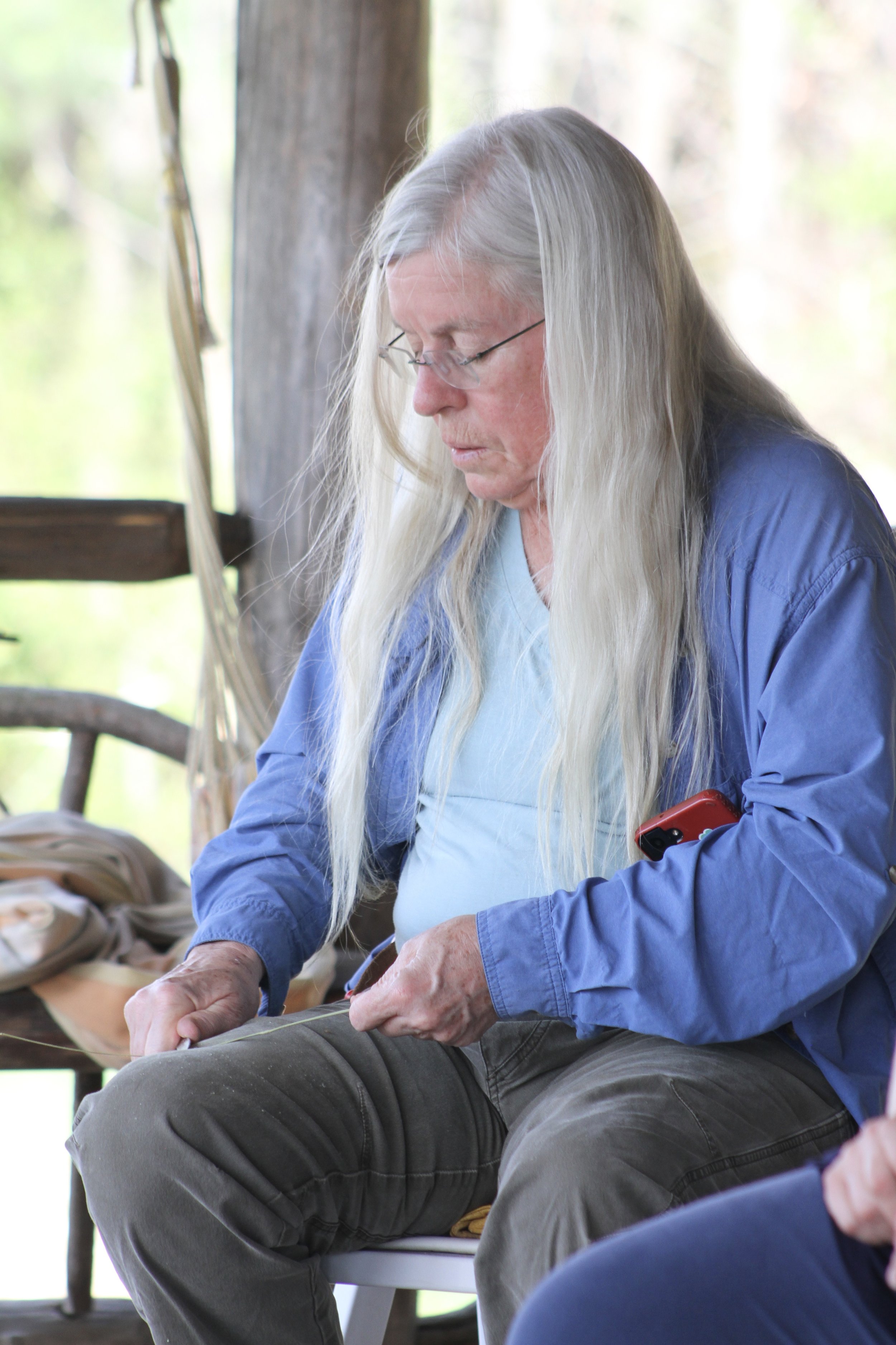  A community member scrapes a river cane splint during a basket-weaving workshop at Warren Wilson College in Swannanoa, N.C., on March 26. (Vivian Bryan/Echo) 