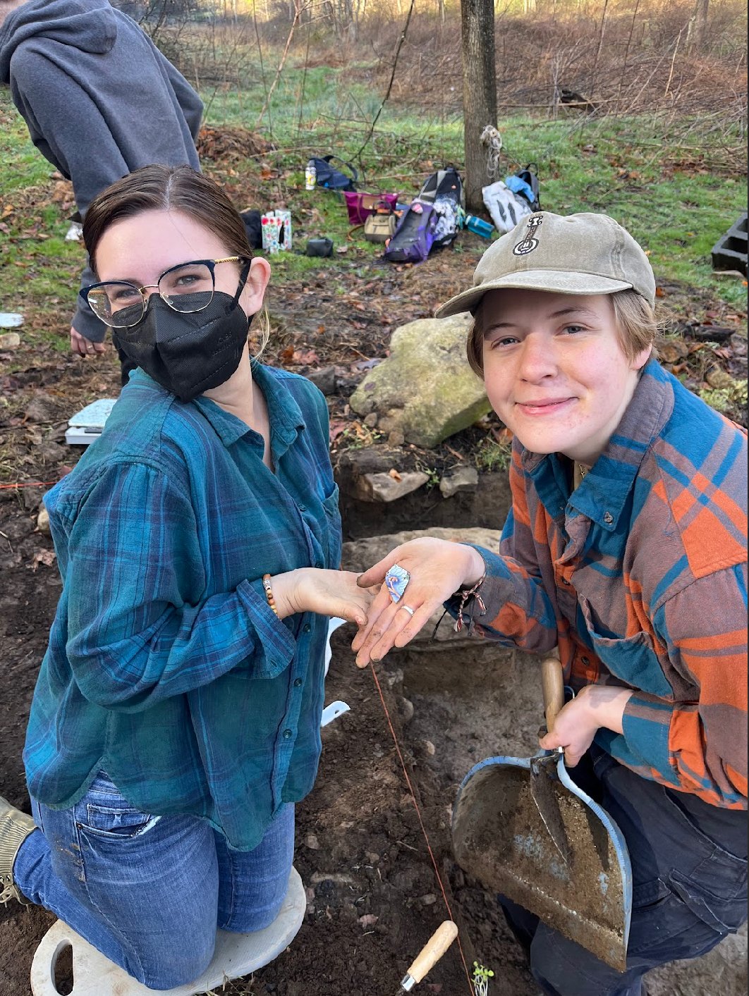  Ava McKinney-Taylor and Richmond Joyce holding porcelain sherd unearthed at Boyd Cabin in Sandy Mush, Buncombe County NC on Mar. 9, 2026. (Echo News/Scotti Norman) 