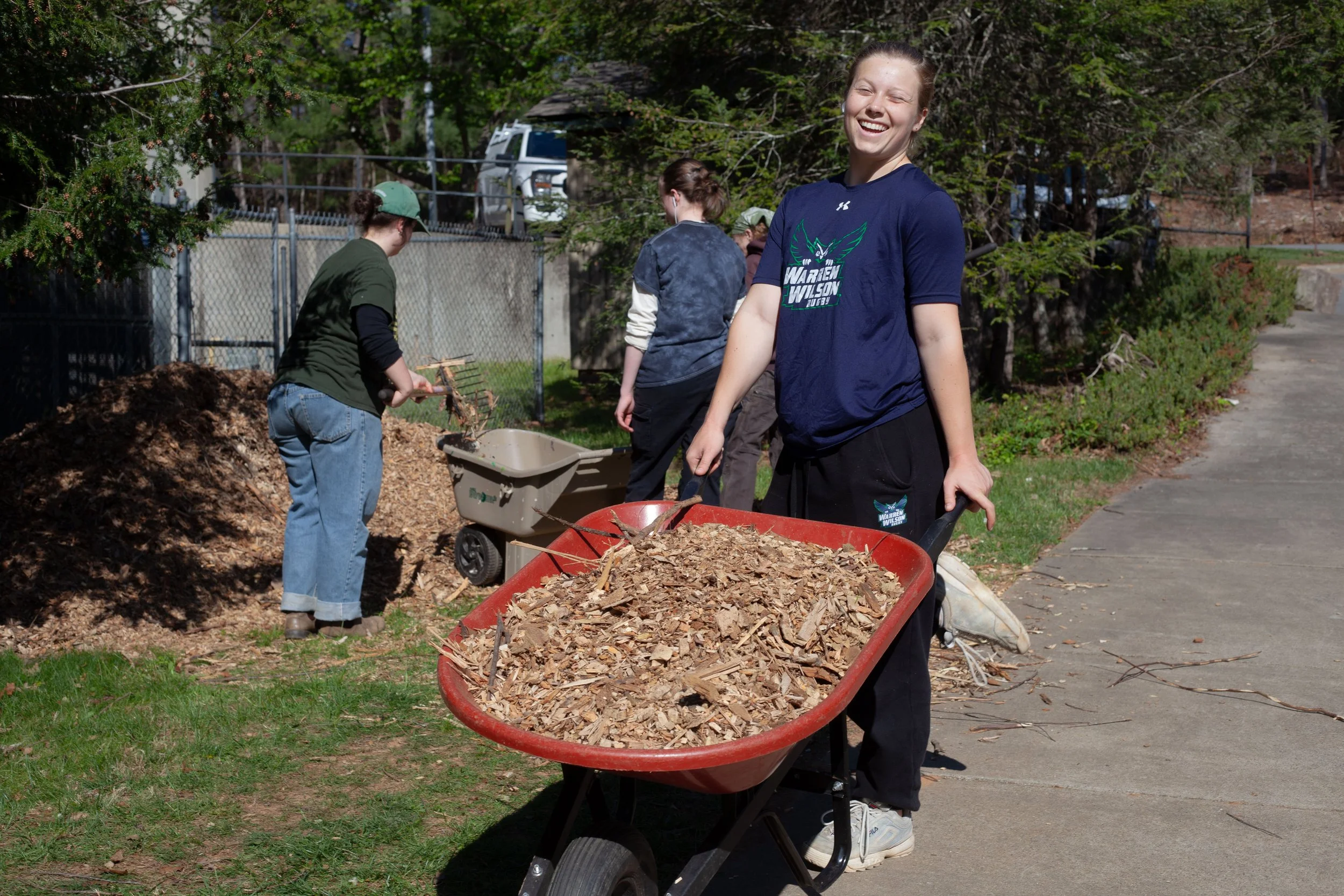 Students work to clean up outdoor spaces at Warren Wilson College (WWC) on Thursday, April 9, in Swannanoa, N.C. (Echo/Emma Taylor McCallum)