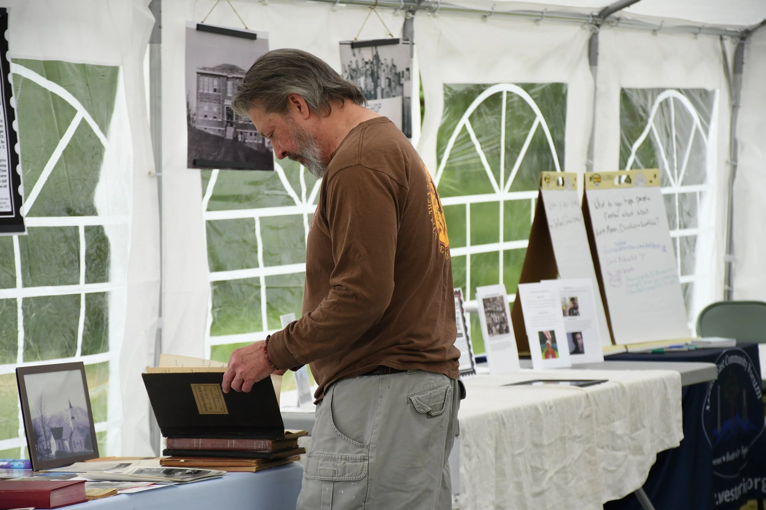  Marion citizen perusing historical books at the homecoming in Marion, McDowell County NC on April 25 2026. (Richmond Joyce/Echo News) 