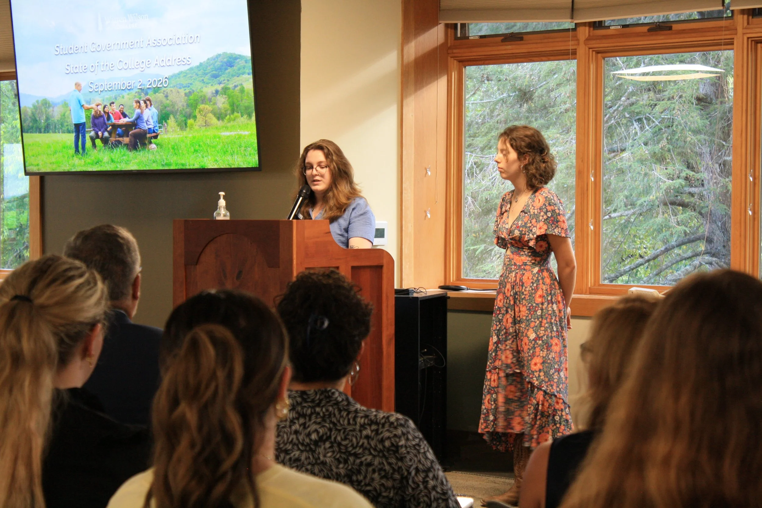  Co-president of the Student Government Association at Warren Wilson College, Lauren Holding and Rianna Baecher speak in front of students at the State of the College Address on Sep. 2, 2026, Swannanoa, N.C. (Echo/Emma Taylor McCallum) 